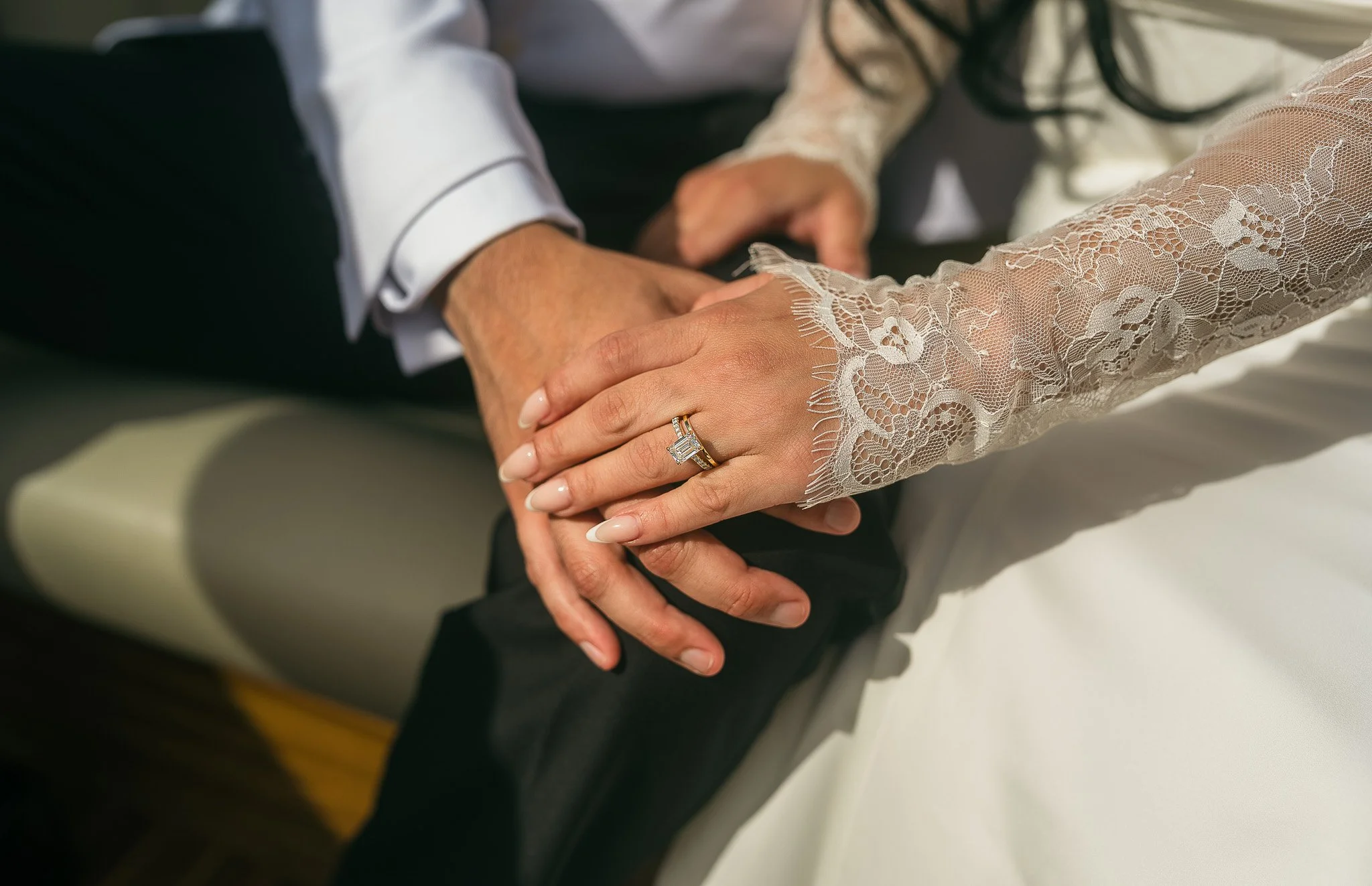 Editorial portrait of a bride and groom holding hands on a boat in Lake Como, Italy on the way to Villa del Balbianello
