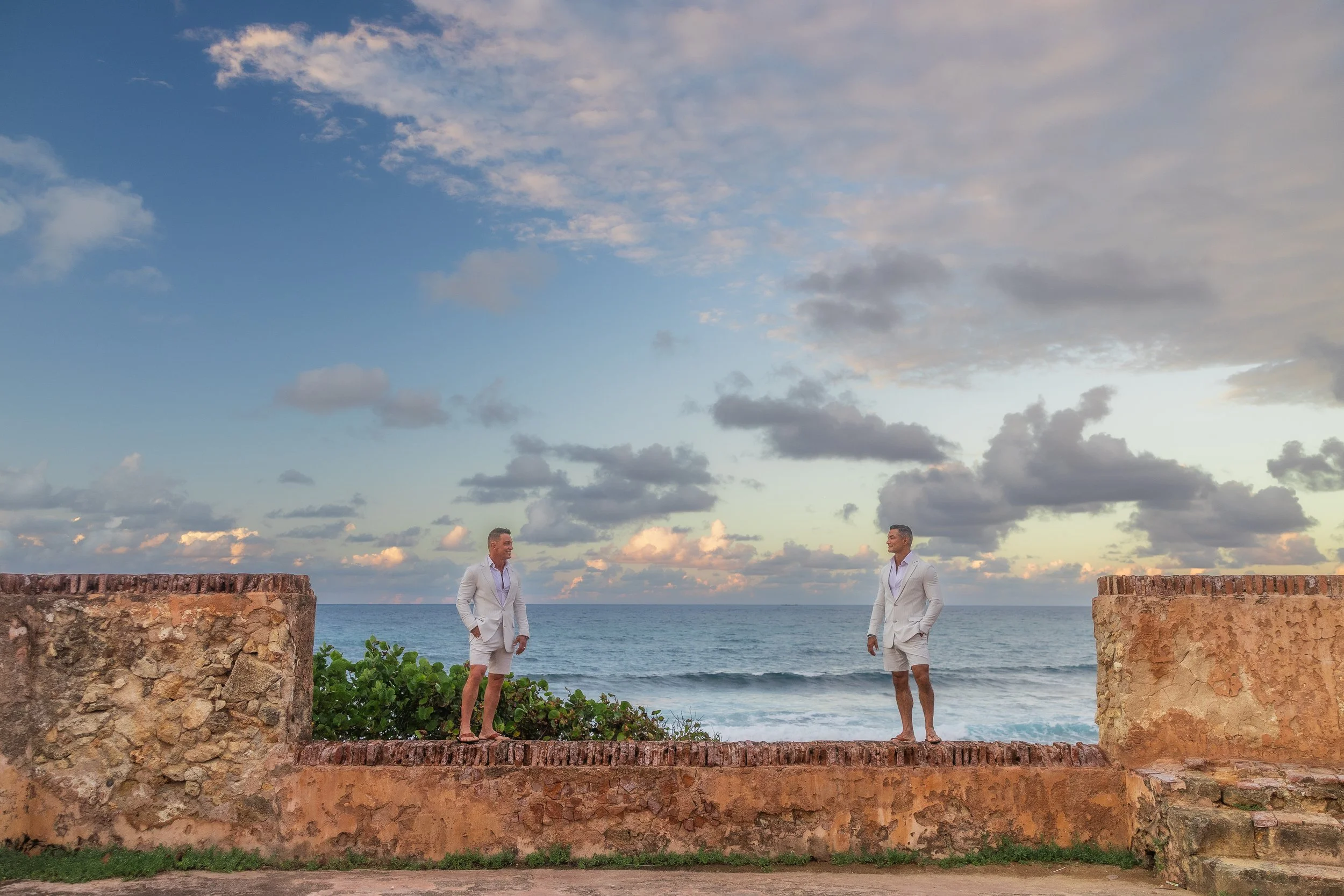 Grooms looking at each other after their gay elopement shot by an LGBT friendly wedding photographer in Puerto Rico