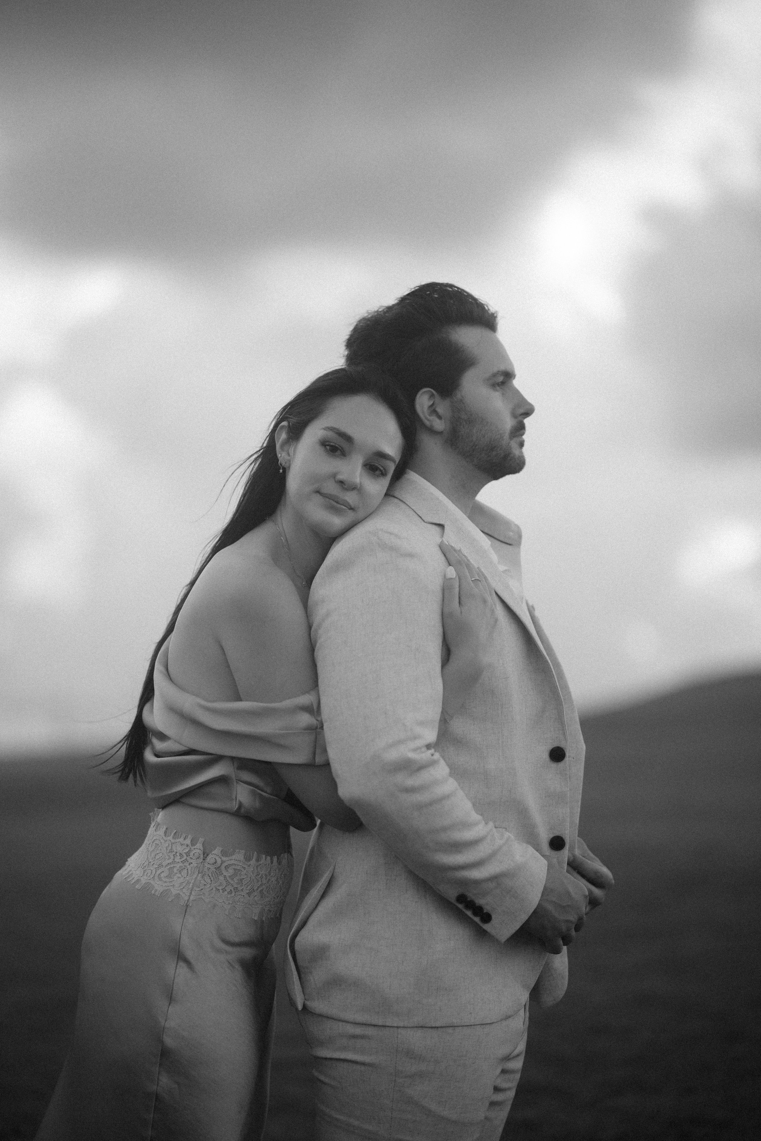 Couple embracing at El Morro during their marriage proposal in Puerto Rico taken by a destination wedding photographer