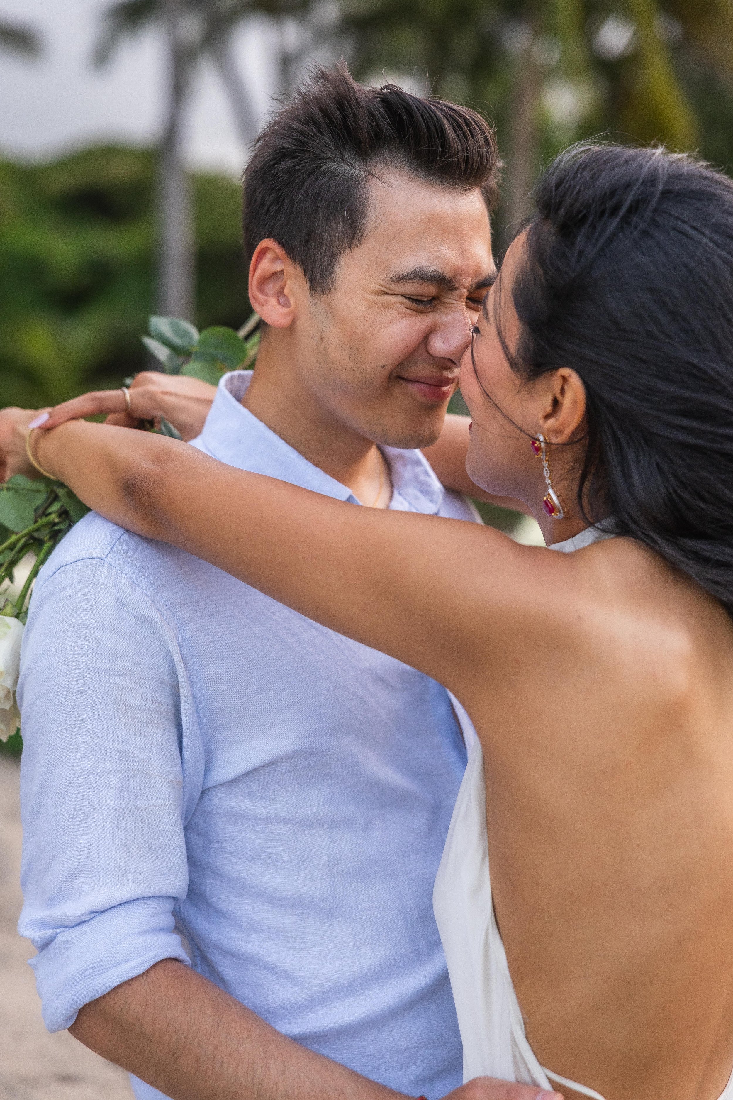 Romantic close-up portrait of Brijend and Sumi embracing and kissing at Seven Seas Beach during their Puerto Rico marriage proposal.