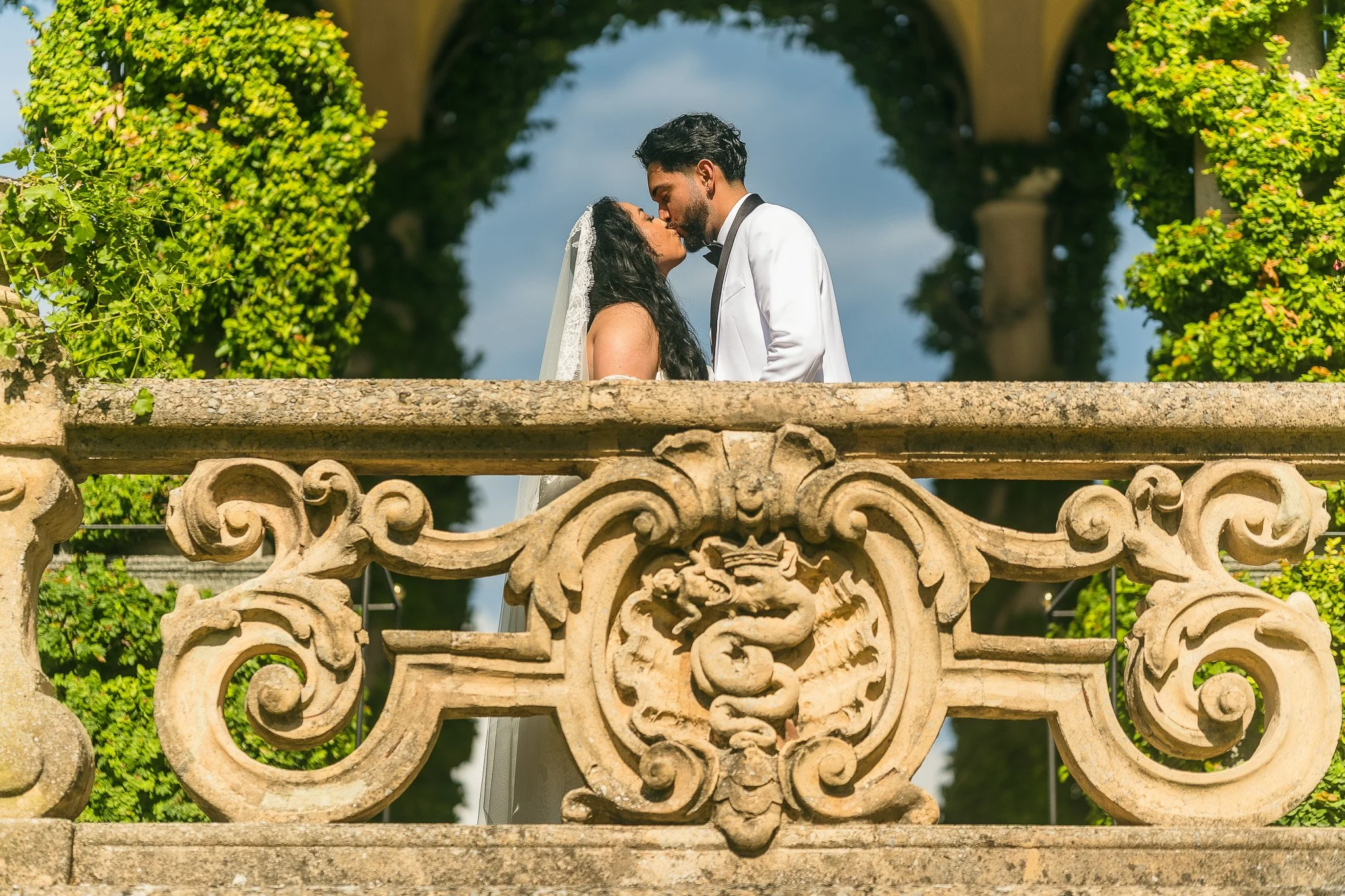 Bride and groom kissing during their luxury elopement wedding at Villa del Balbianello in Lake Como, Italy
