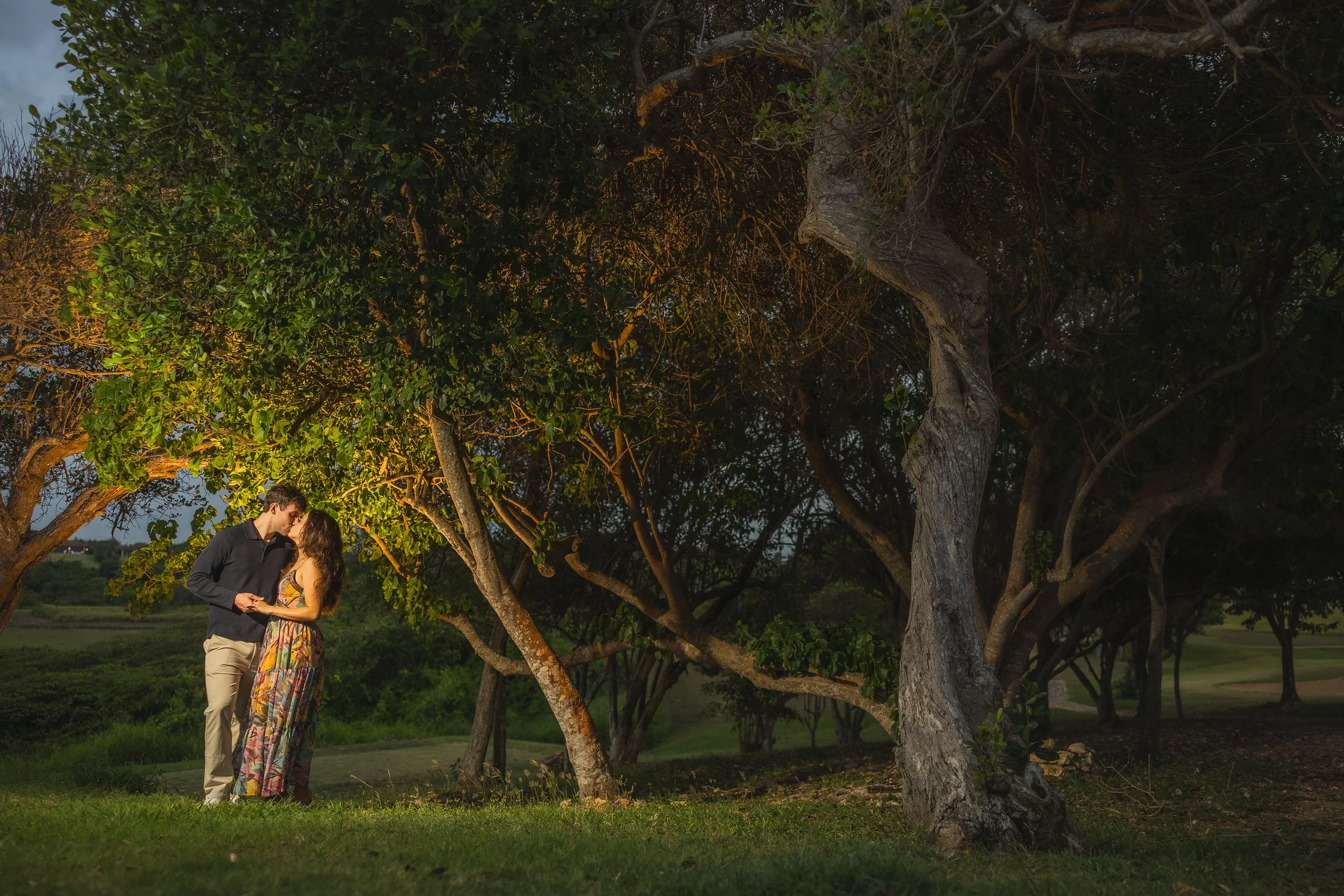 Couple embracing at Royal Isabela in Puerto Rico taken by a surprise marriage proposal photographer during an engagement session