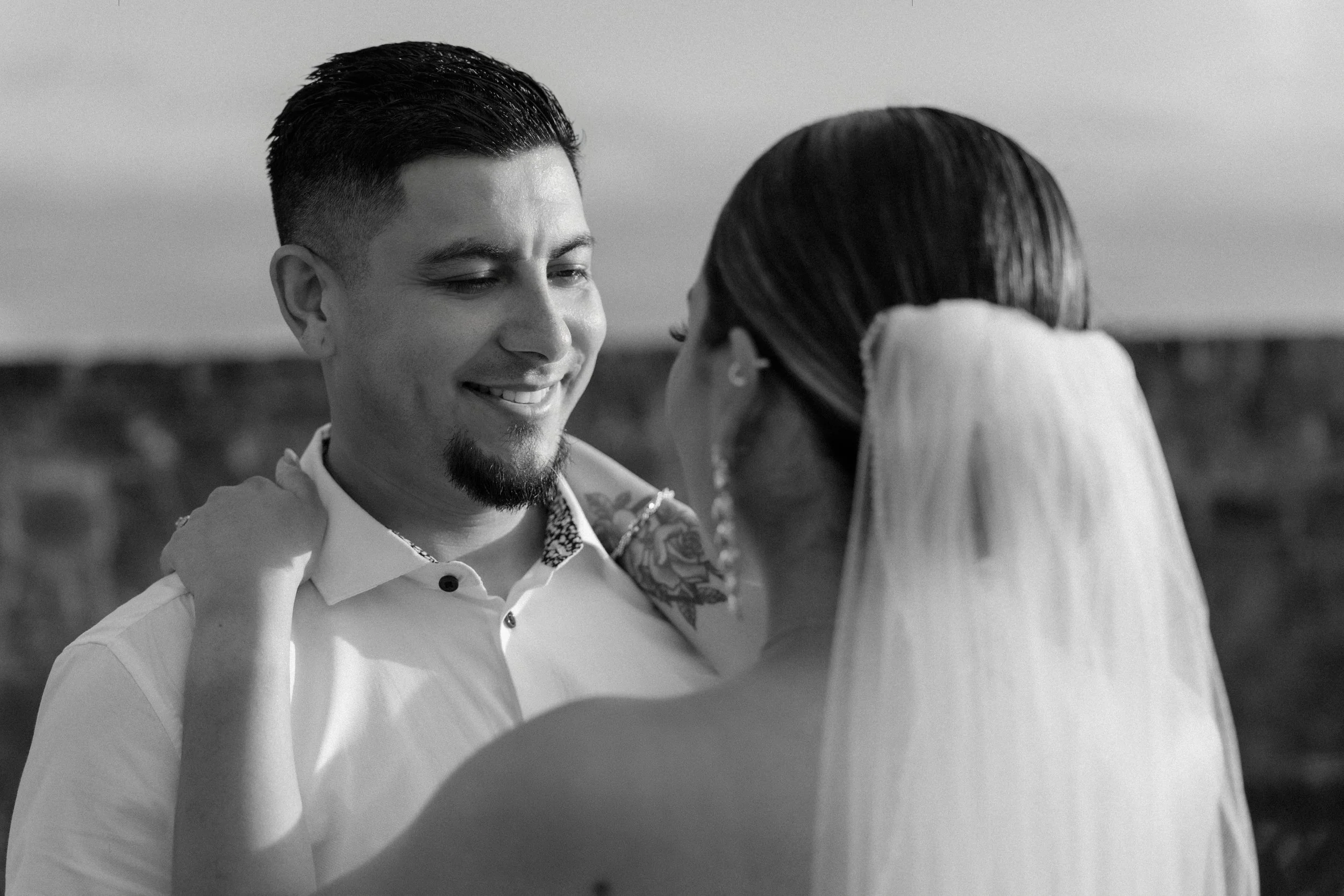 Black and white portrait of the groom gazing into bride's eyes in Old San Juan during their elopement wedding in Puerto Rico