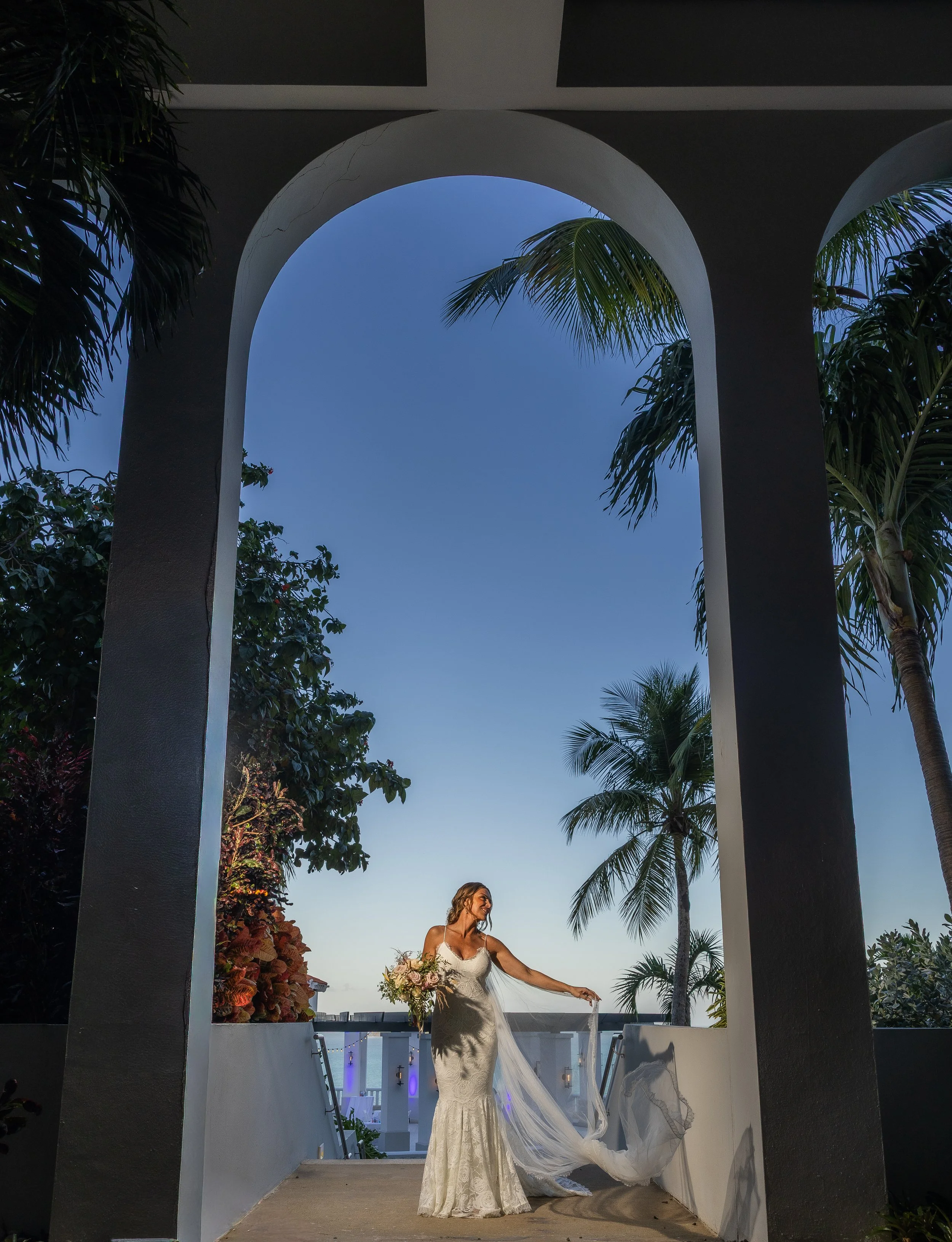 Bride playing with her dress at El Conquistador Resort taken by a luxury wedding photographer in Puerto Rico
