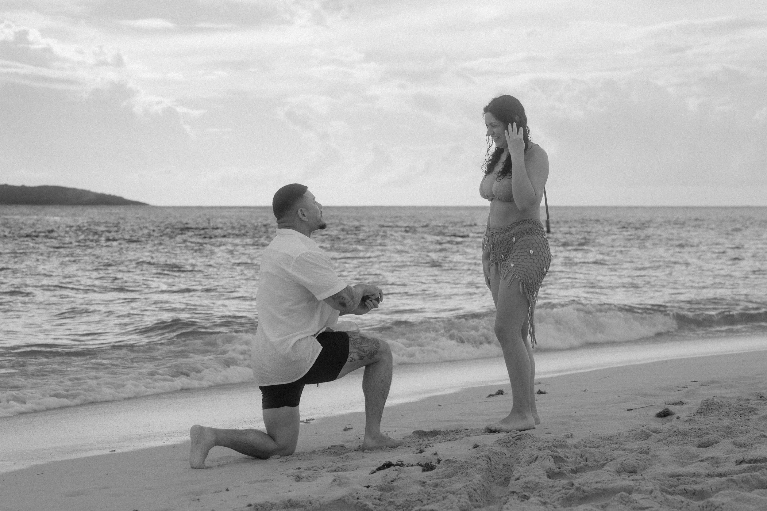 Man proposing on one knee at Icacos Island Puerto Rico beach