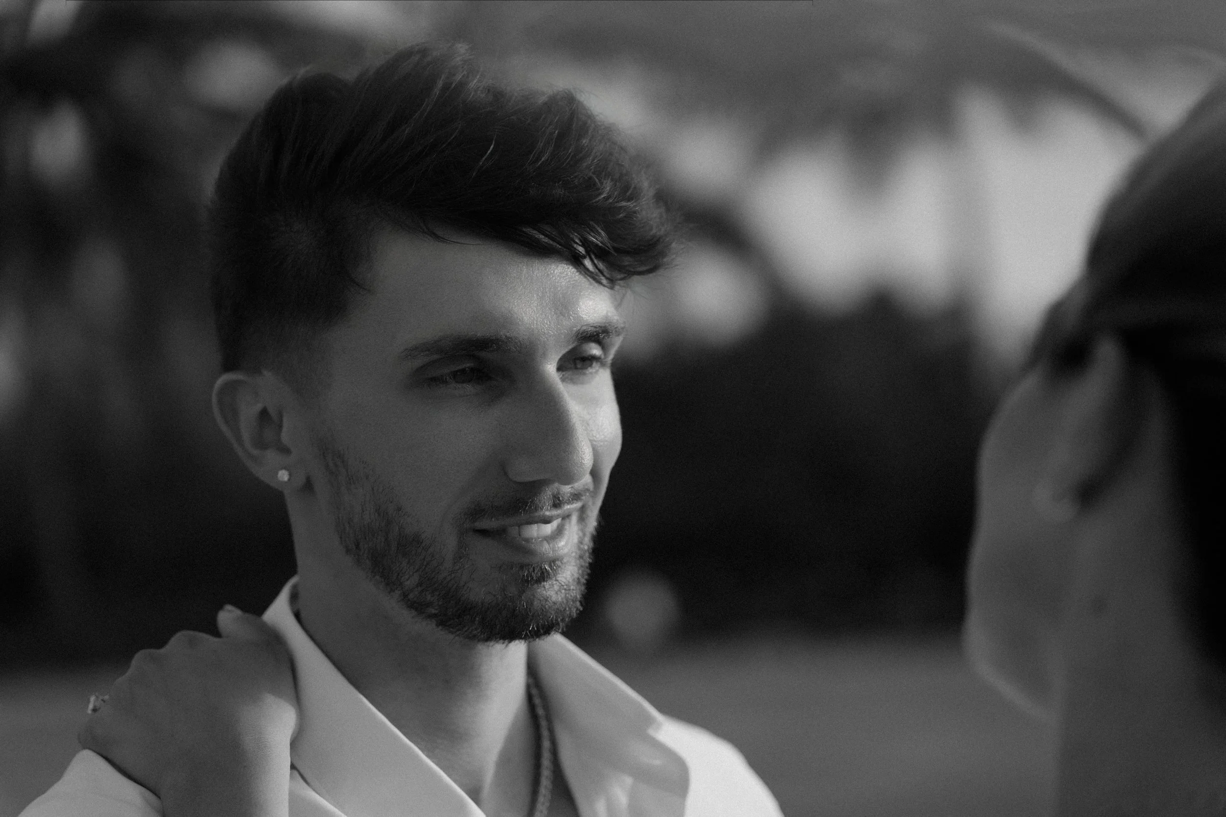 Man smiling during her engagement session in Puerto Rico taken by a marriage proposal photographer at Escambrón Beach