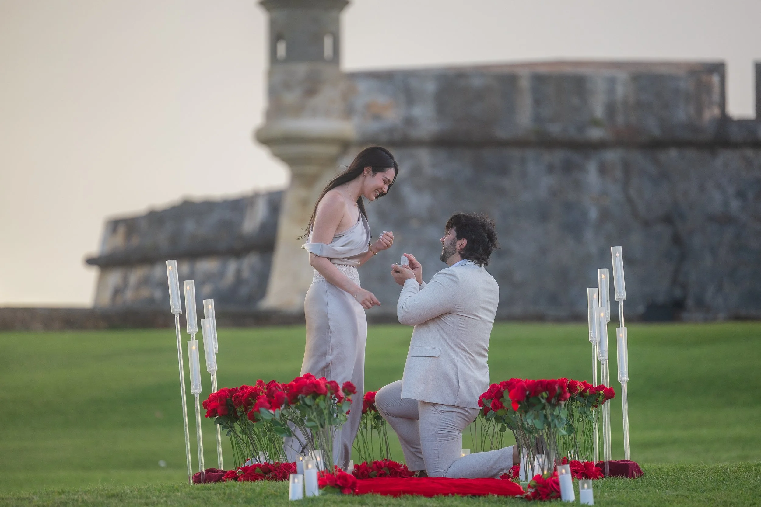 Man proposing to woman at El Morro in Old San Juan taken by a Puerto Rico elopement wedding photographer