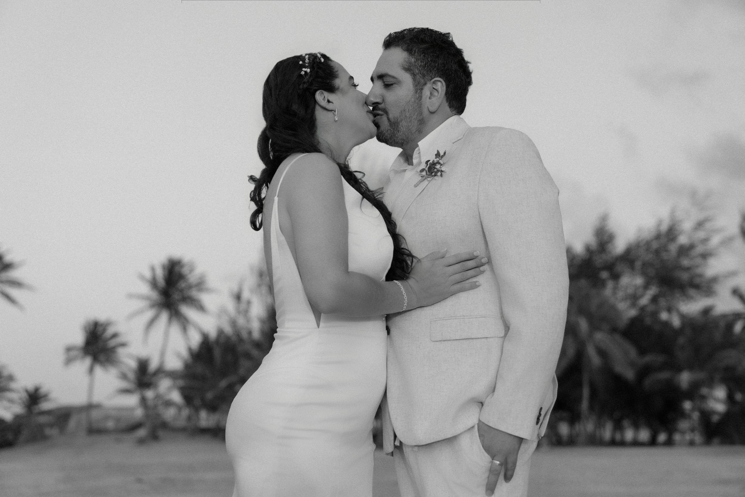 Bride and groom kissing during an intimate elopement in Puerto Rico at Escambrón Beach