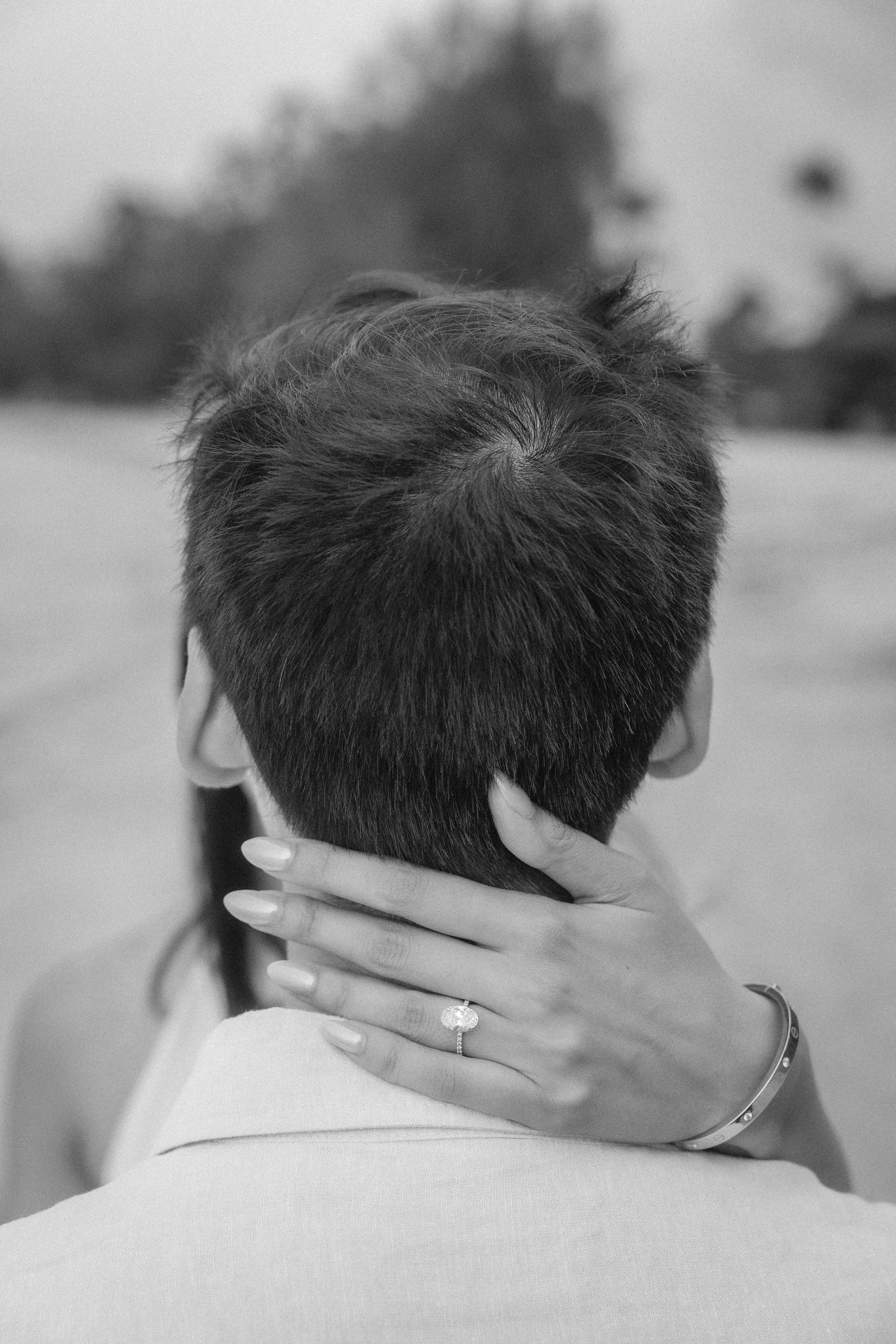 Intimate black and white photograph of Sumi embracing Brijend at Seven Seas Beach in Fajardo, Puerto Rico, highlighting her engagement ring.