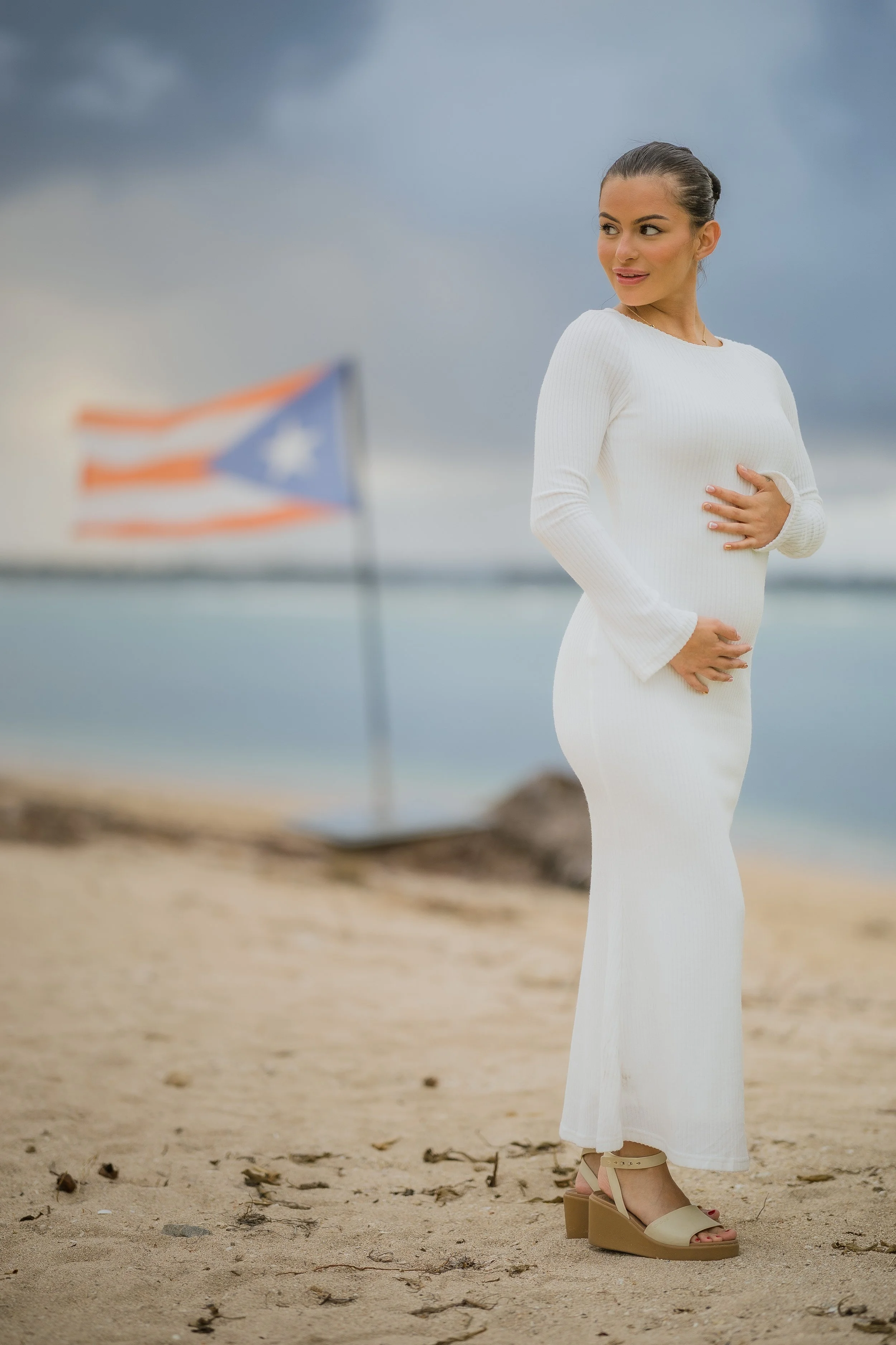 Woman posing showing her belly during a maternity photography session at the Hyatt Regency Grand Reserve in Puerto Rico