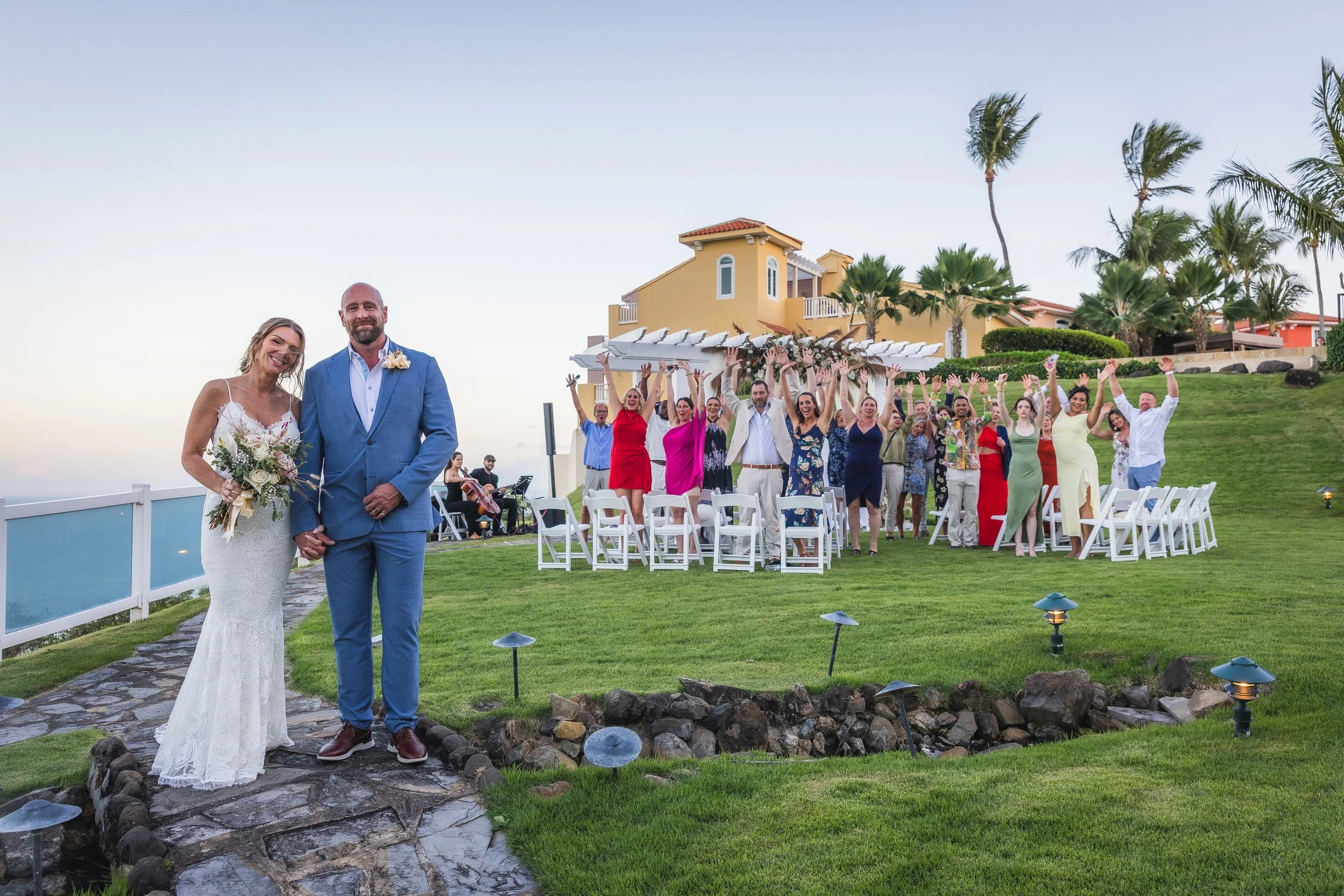 Bride and groom posing with entourage at El Conquistador Resort taken by an editorial wedding photographer in Puerto Rico