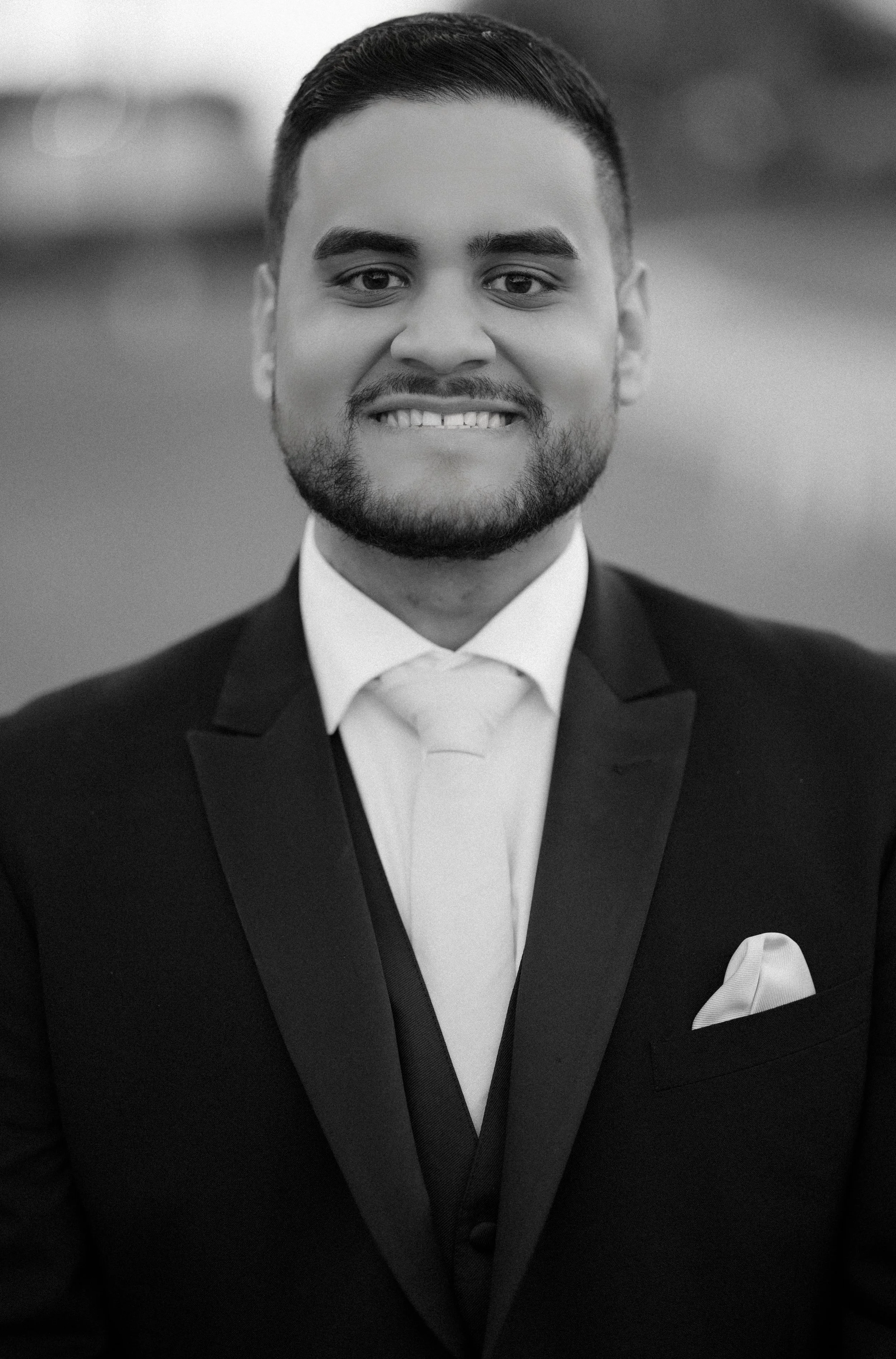 Groom posing for the camera of a Miami, Florida wedding photographer during his luxury ceremony at Indian Spring Country Club.