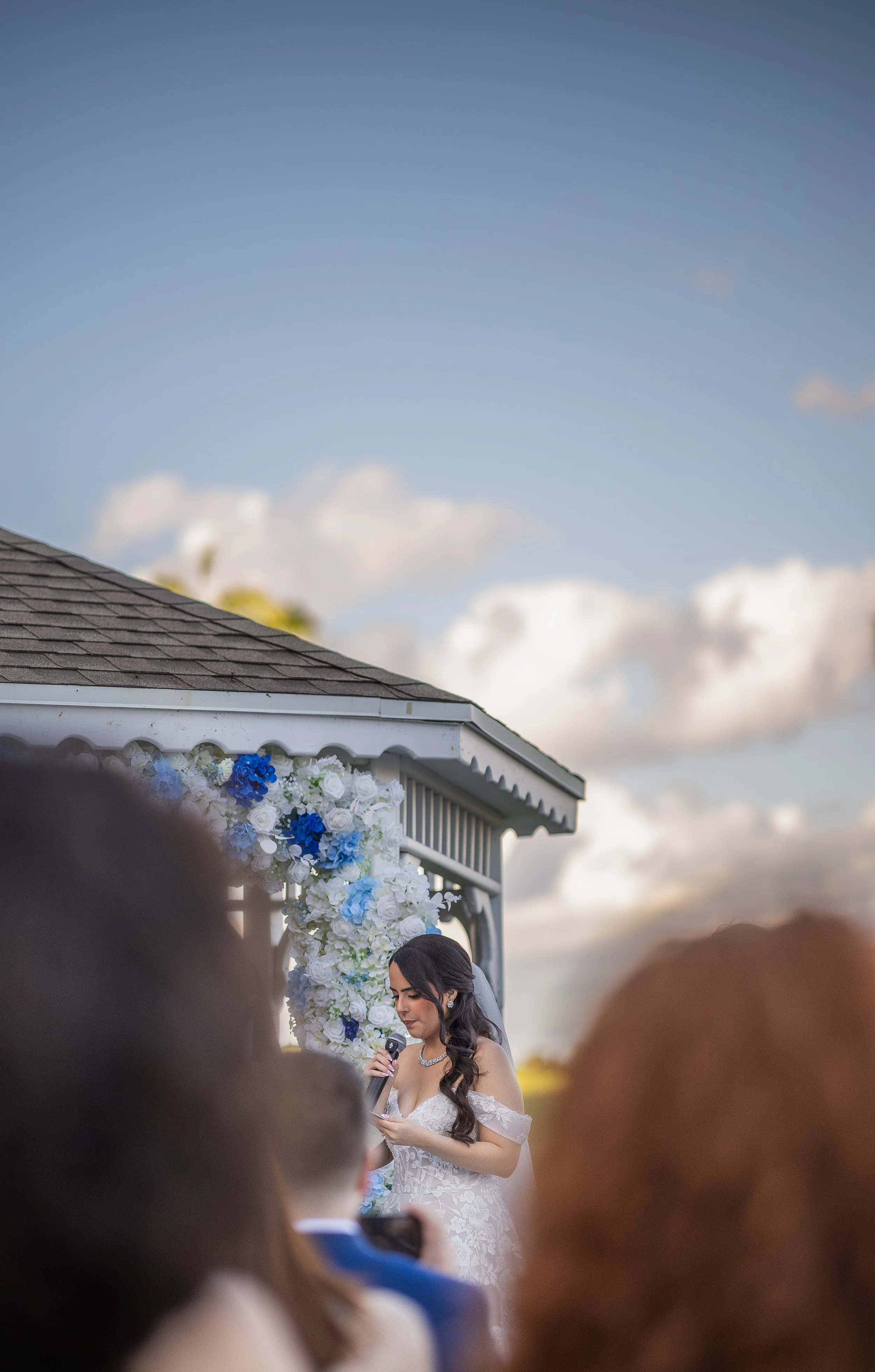 Groom listening to bride's vows during their luxury wedding ceremony at Indian Spring Country Club in Boynton Beach, Florida.