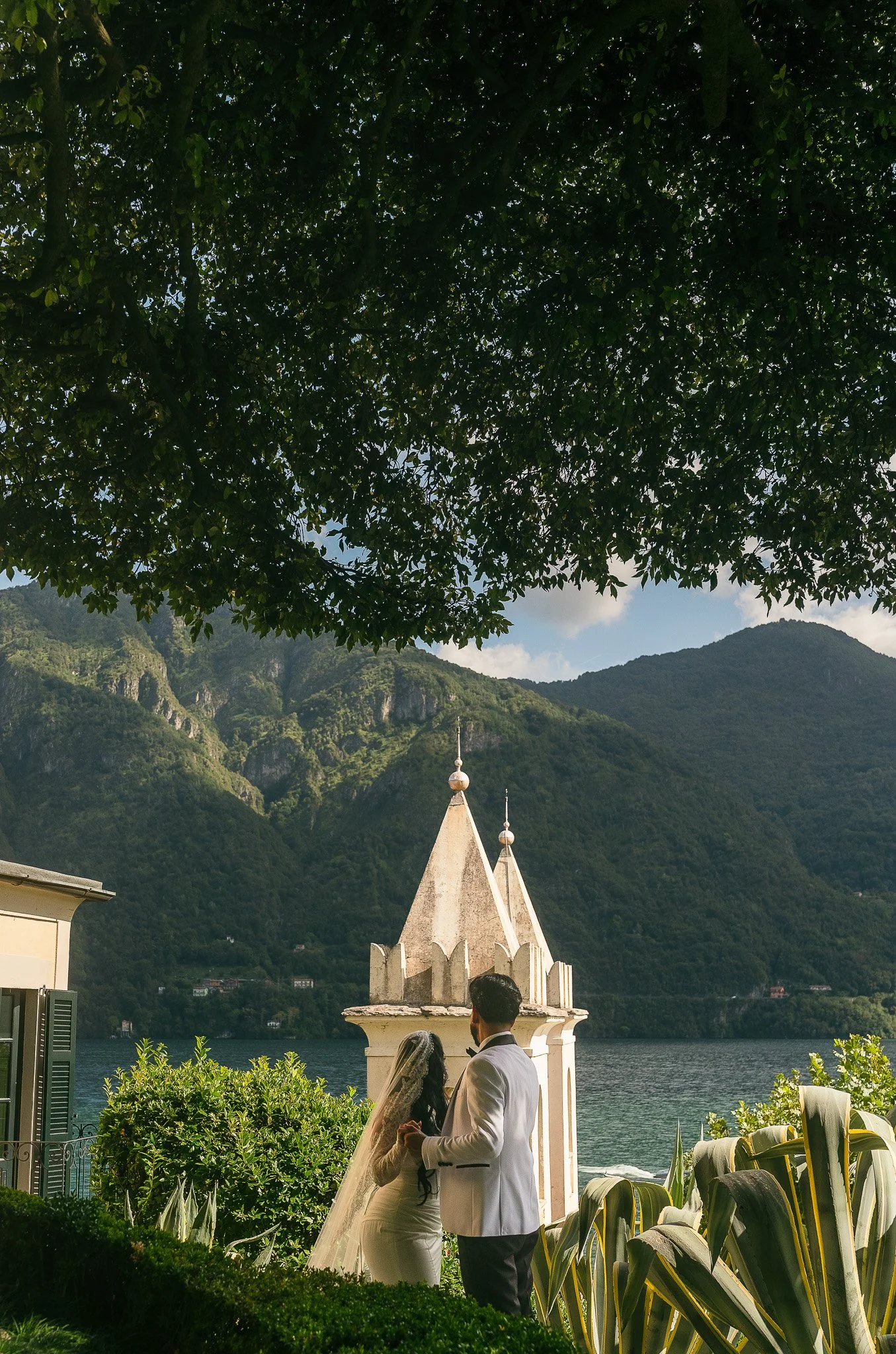 Bride and groom overlooking Lake Como from Villa del Balbianello during their luxury, editorial elopement taken by a destination wedding photographer