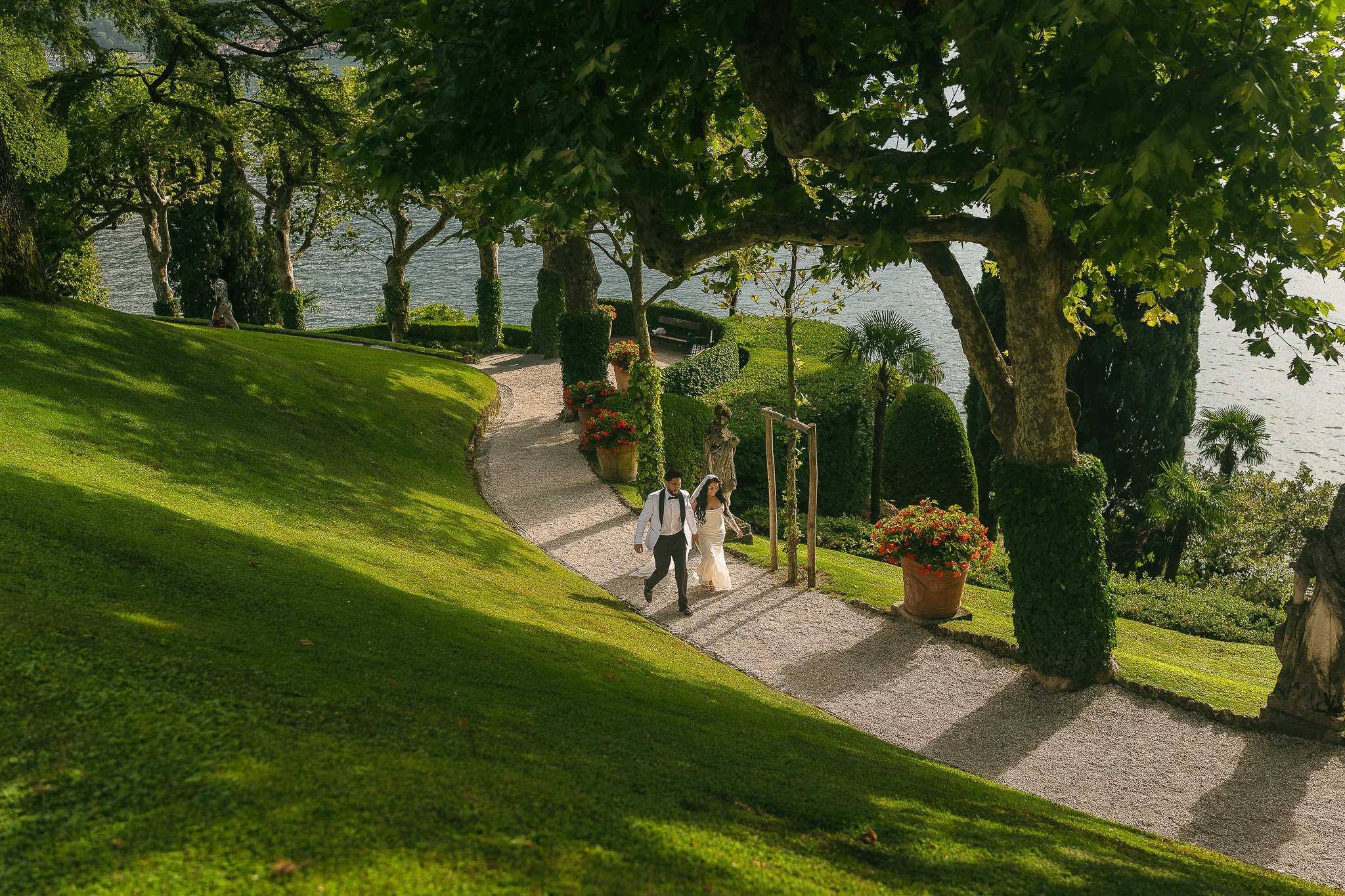 Bride and groom holding hands at Villa del Balbianello, a luxury wedding venue in Lake Como, Italy shot by a destination wedding photographer