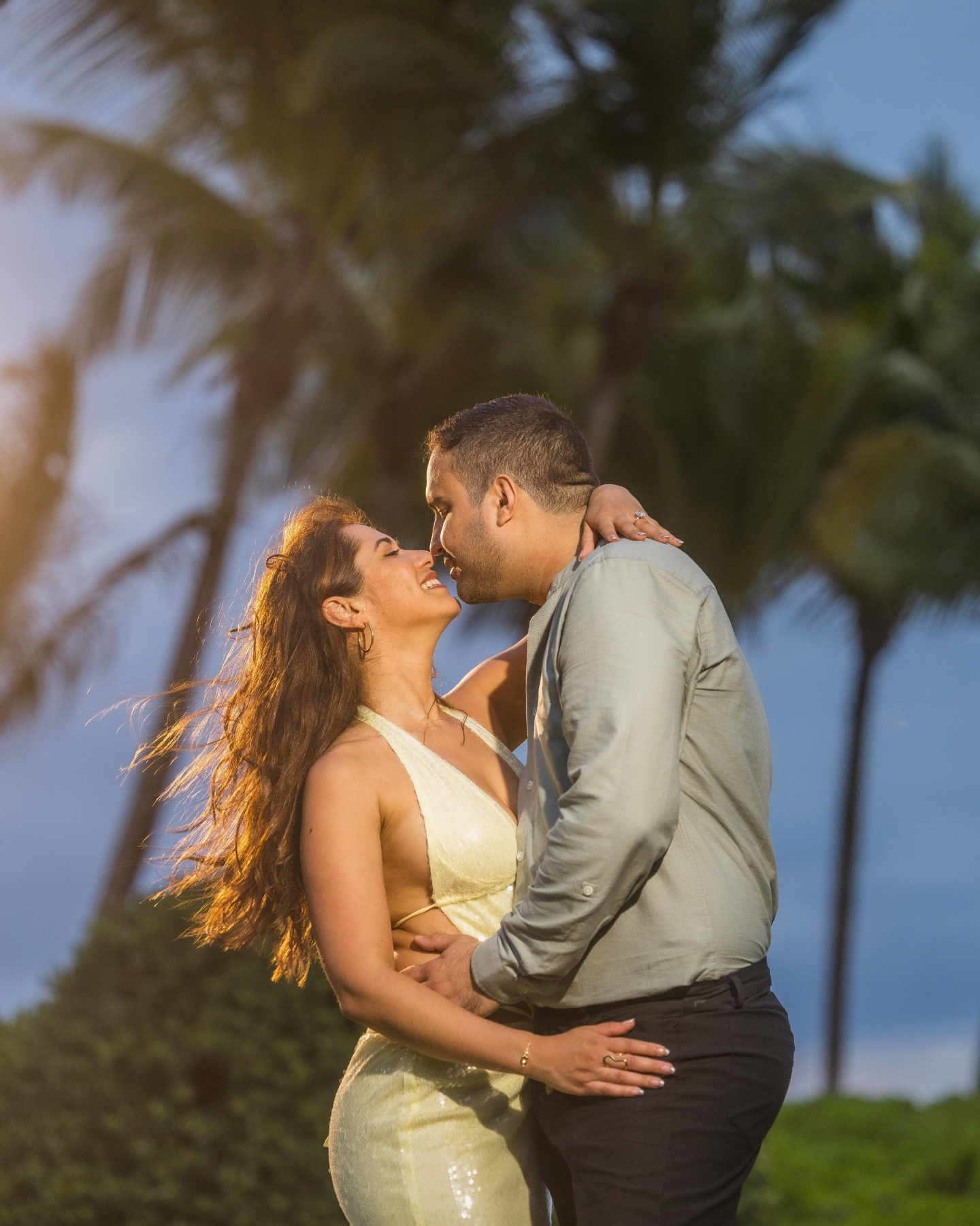 Couple kissing after a surprise marriage proposal at the St. Regis Bahía Beach Resort in Puerto Rico