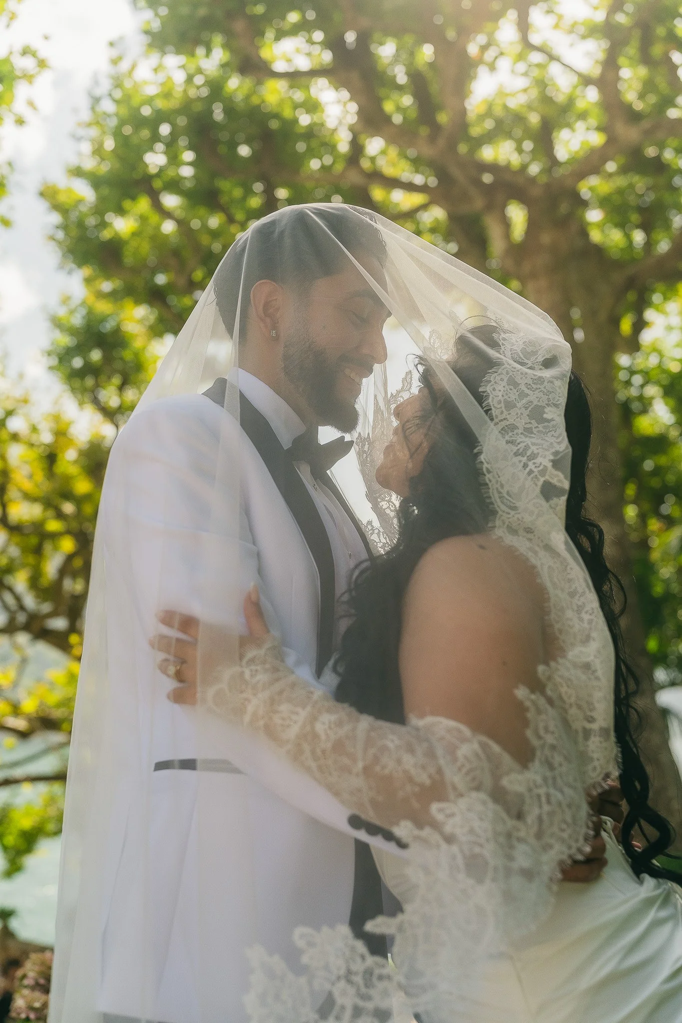 Bride and groom under the veil at Villa del Balbianello, a luxury wedding venue in Lake Como, Italy shot by a destination wedding photographer