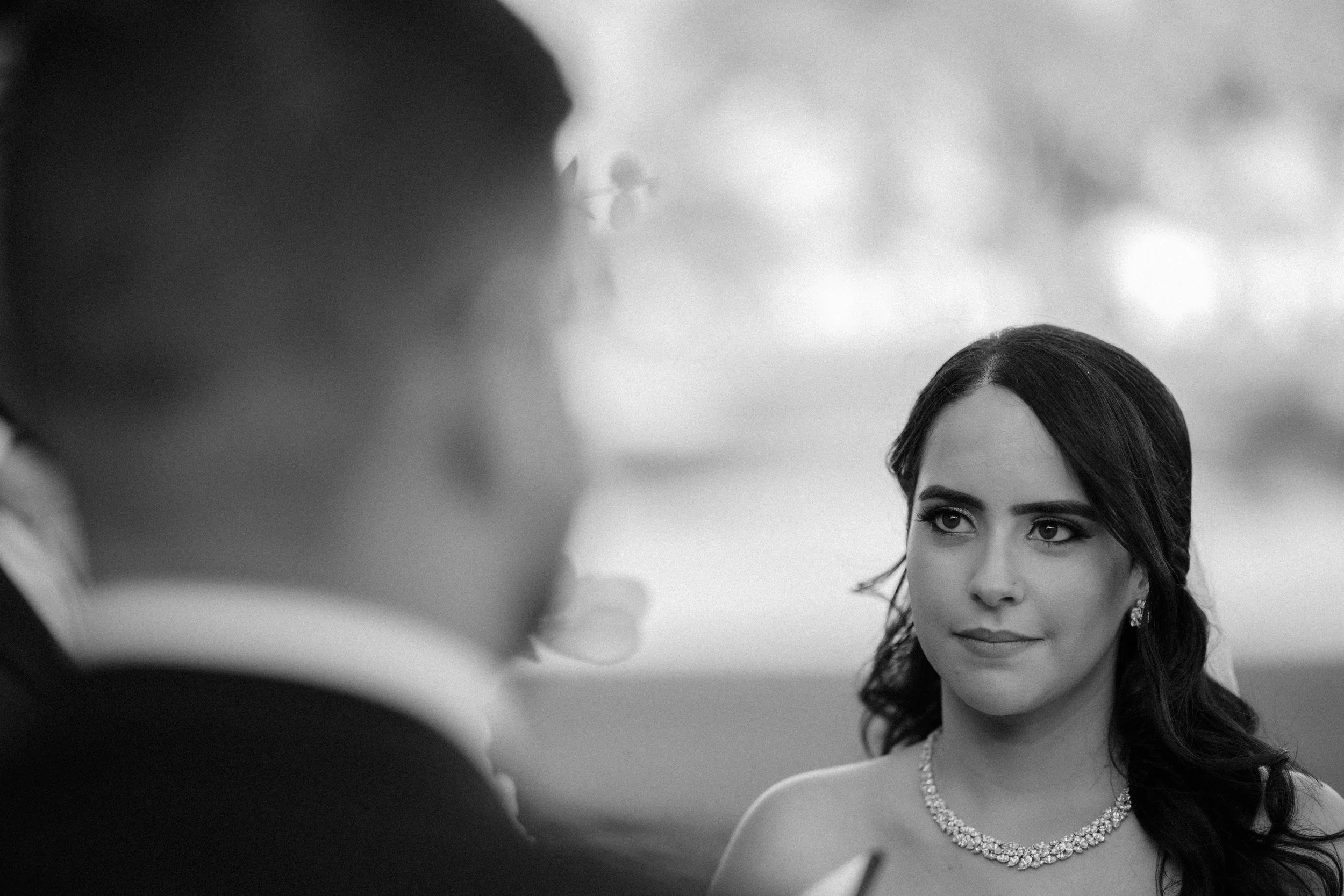 Bride listening to groom's vows during their luxury wedding ceremony at Indian Spring Country Club in Boynton Beach, Florida.