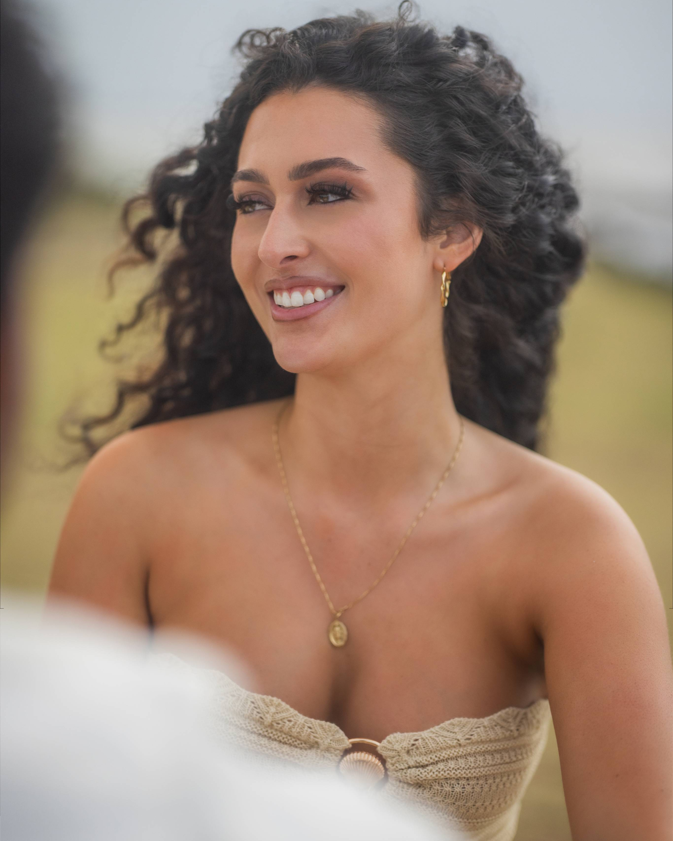 Portrait of Kathleen smiling during a candid conversation moments after her luxury Puerto Rico proposal.