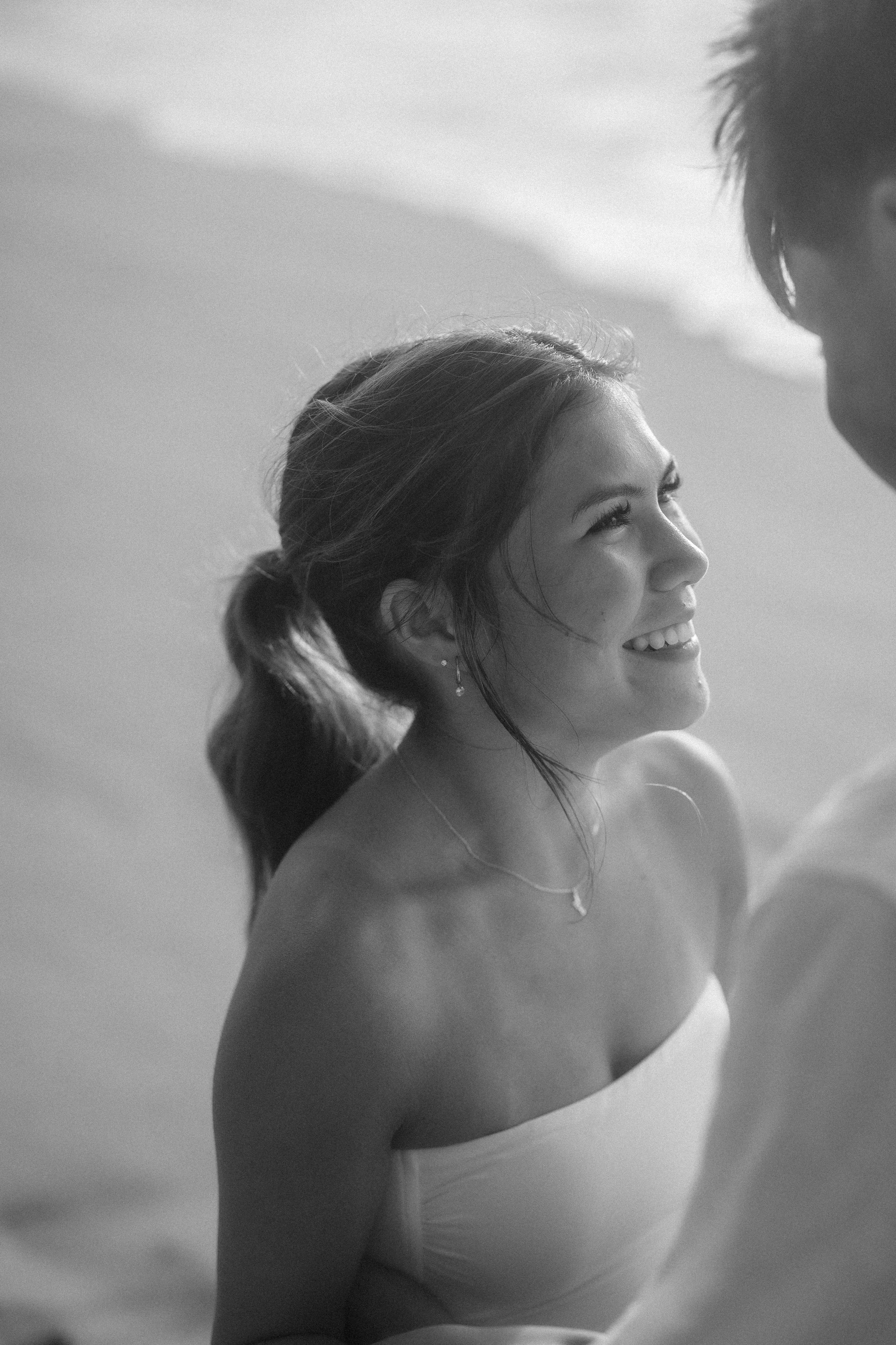 Editorial black and white portrait of a young woman at Punta Borinquen Beach during a surprise marriage proposal in Puerto Rico
