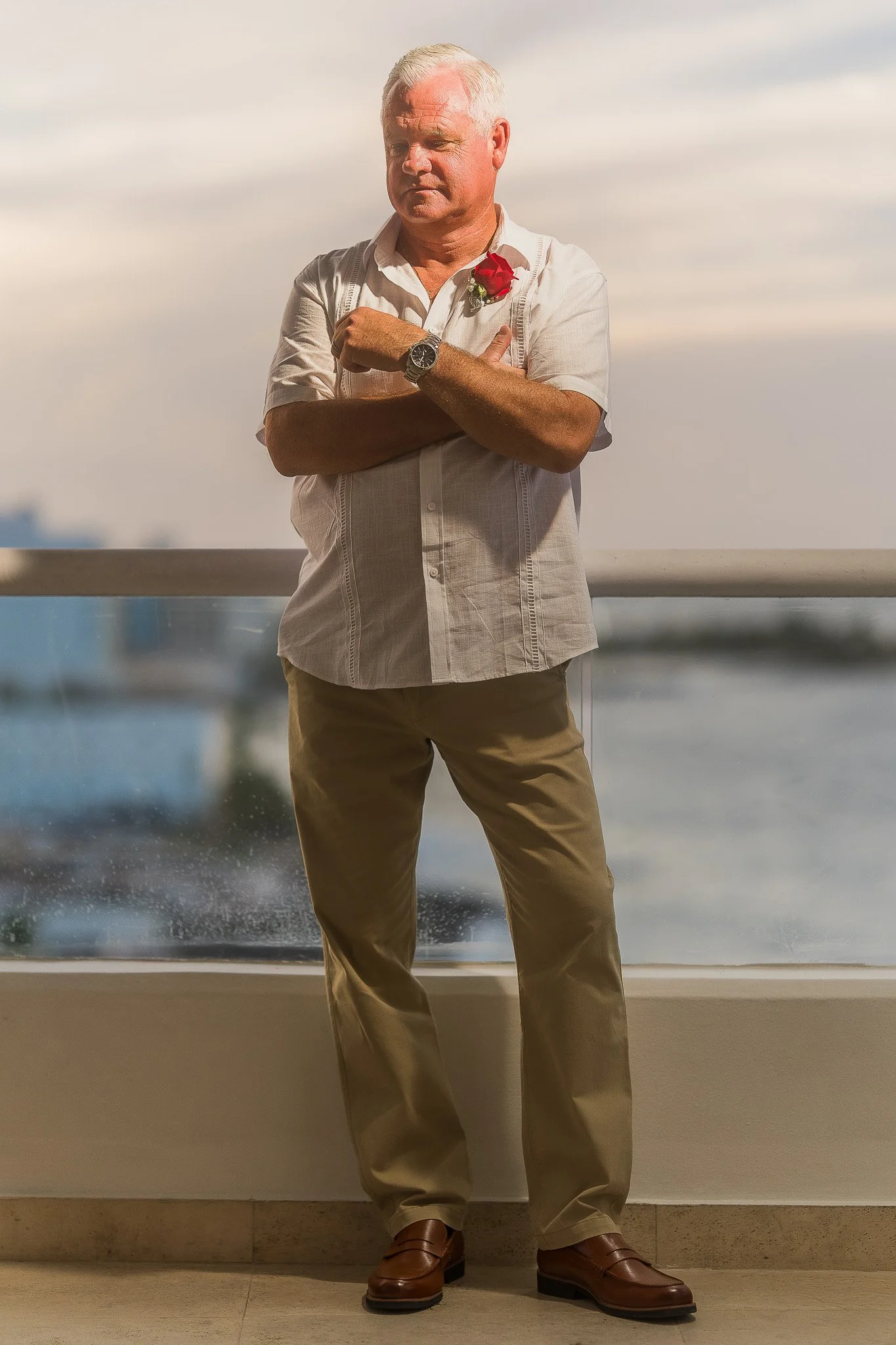 Groom on balcony of the Condado Vanderbilt Hotel during his elopement wedding in Puerto Rico