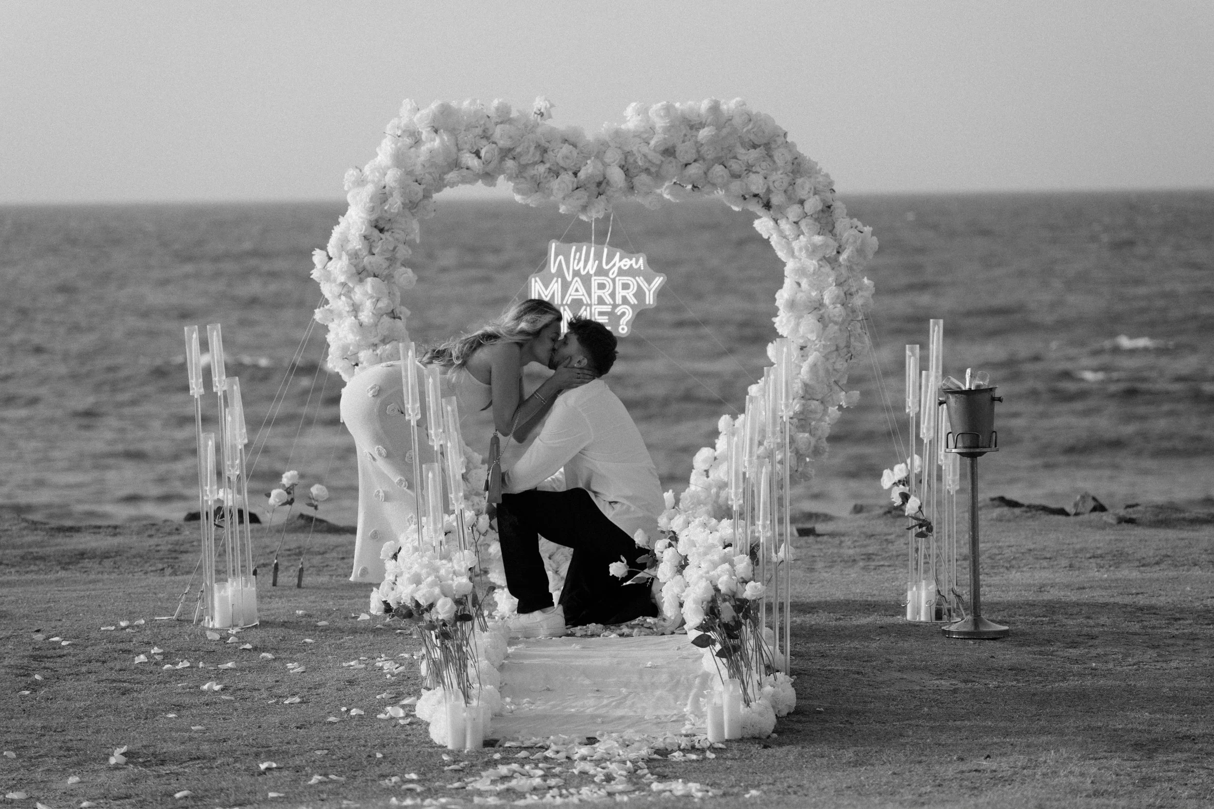 Man proposing to woman at Escambrón Beach during their engagement session in Puerto Rico