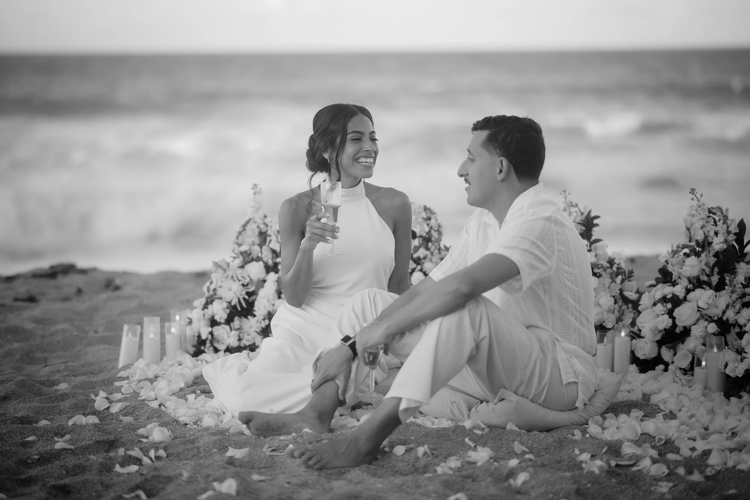 Couple sitting on beach in Puerto Rico after a marriage proposal