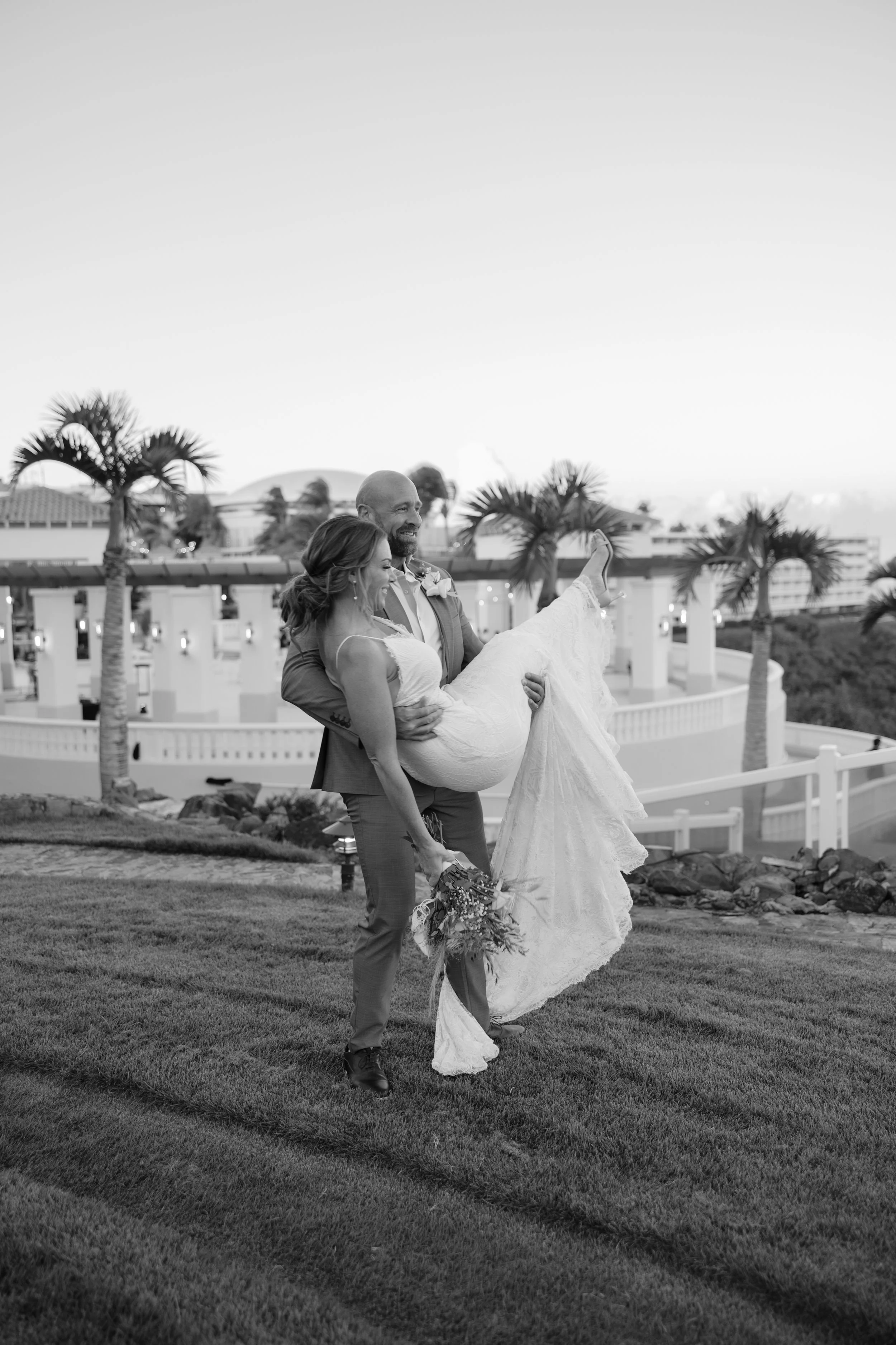 Bride and groom frolicking at El Conquistador Resort during their wedding shot by a photographer in Puerto Rico