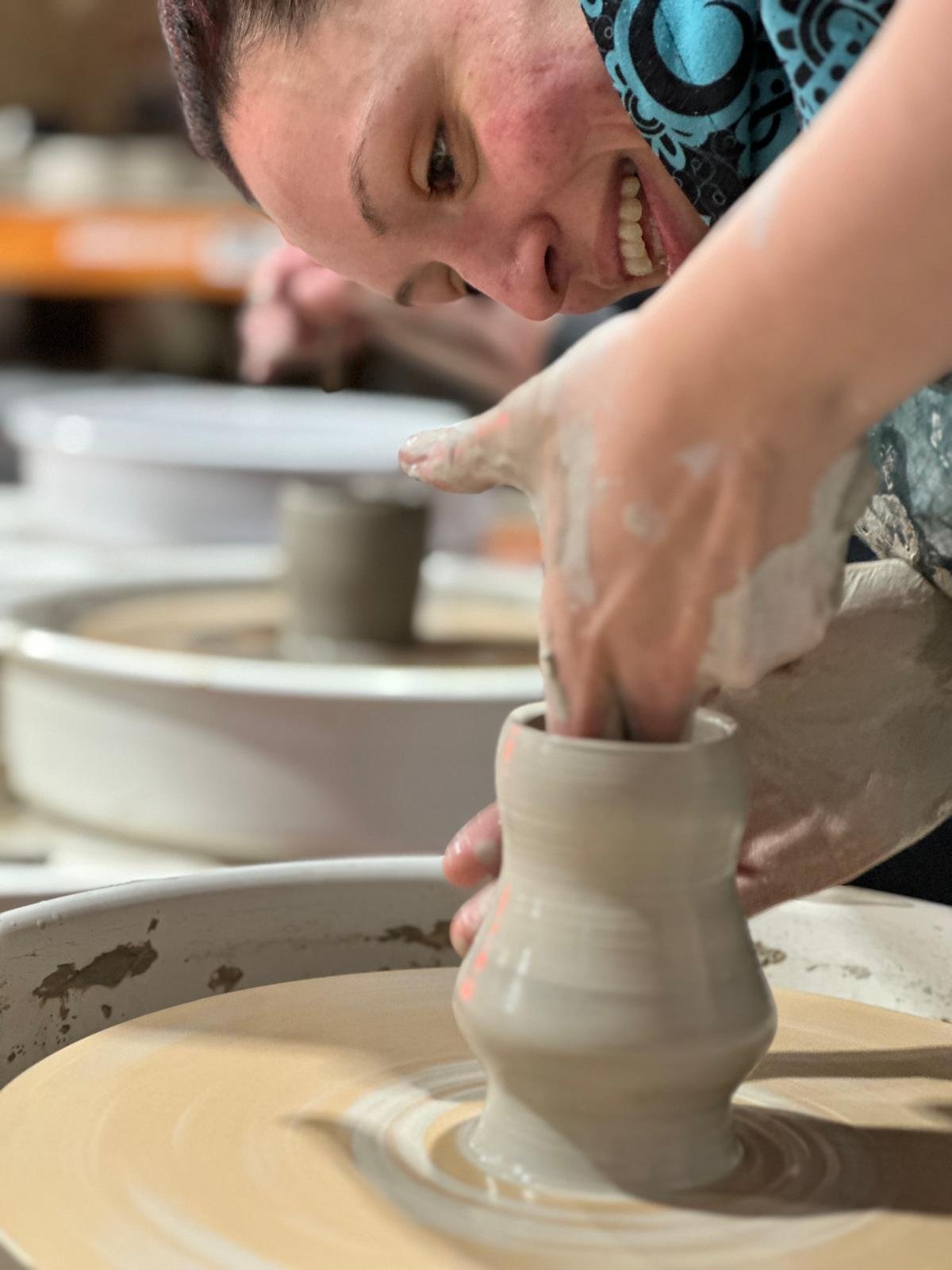 Image of pot being thrown on potters wheel
