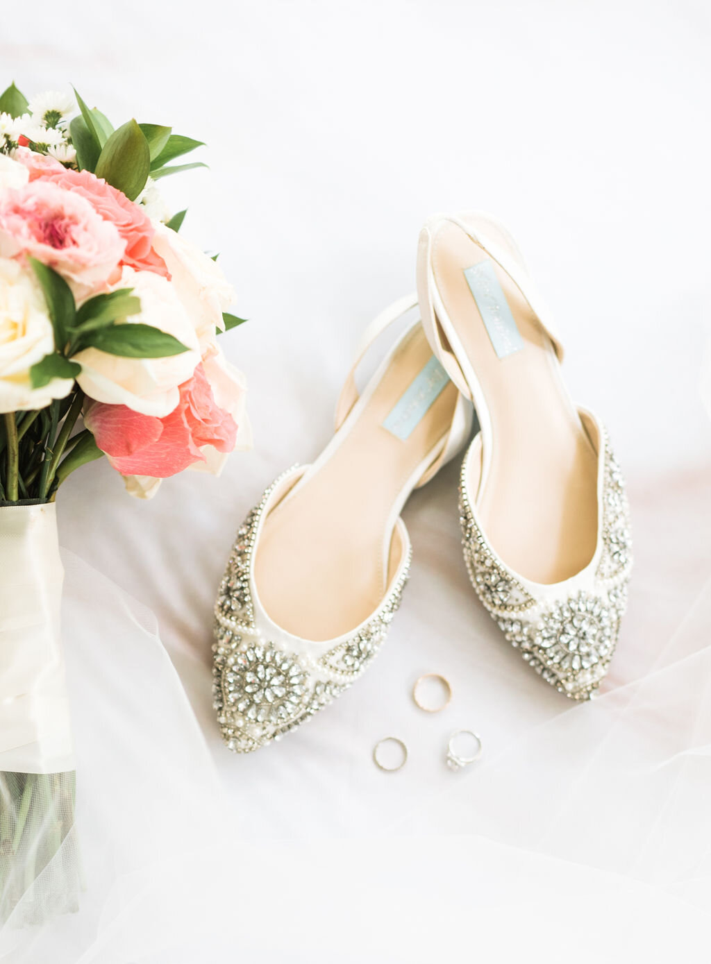 wedding shoes with rings and bouquet details