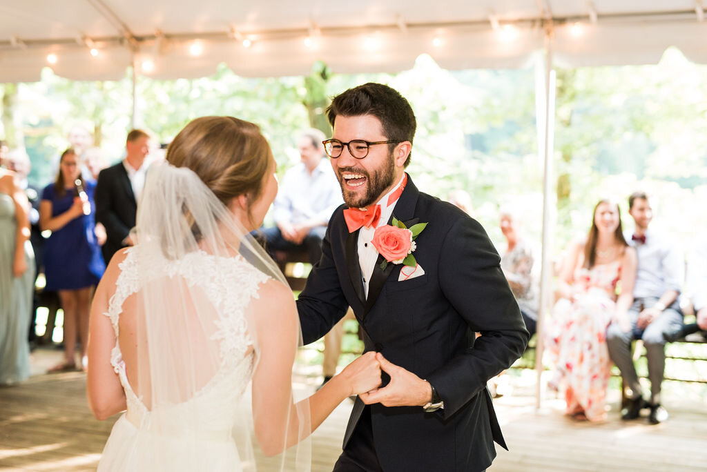 wedding first dance with groom smiling