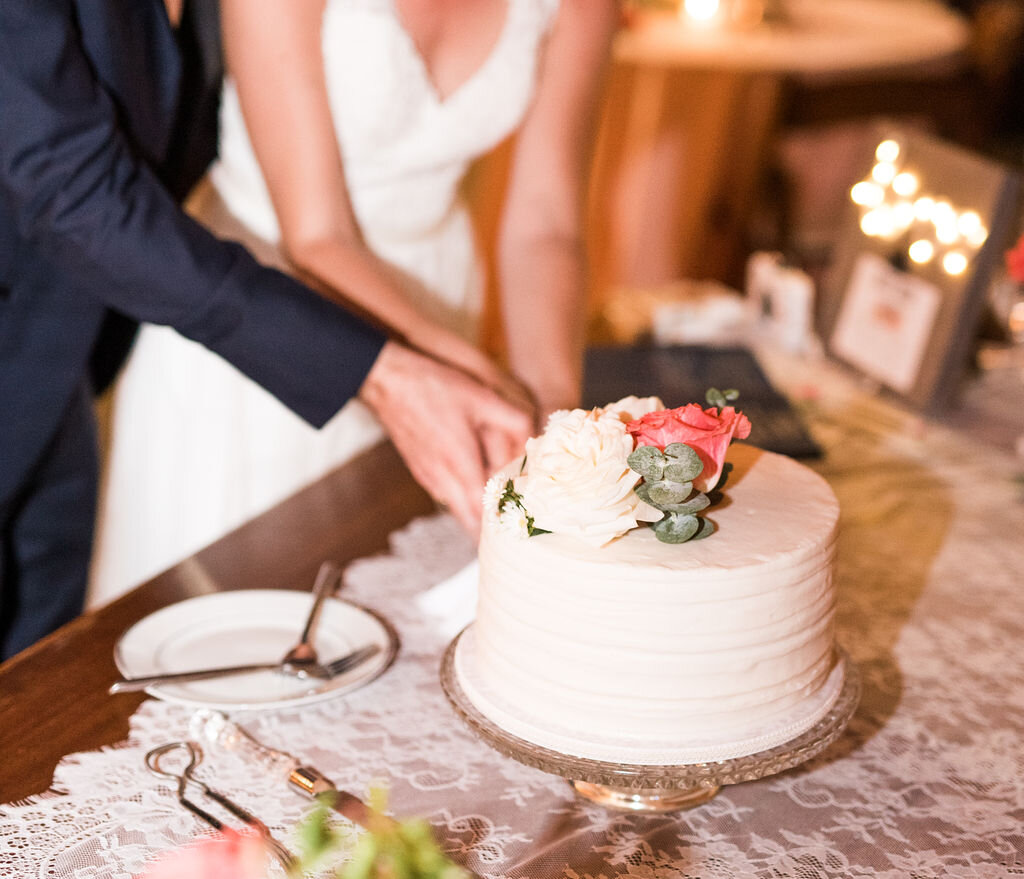 cake cutting with a small white cake with floral details