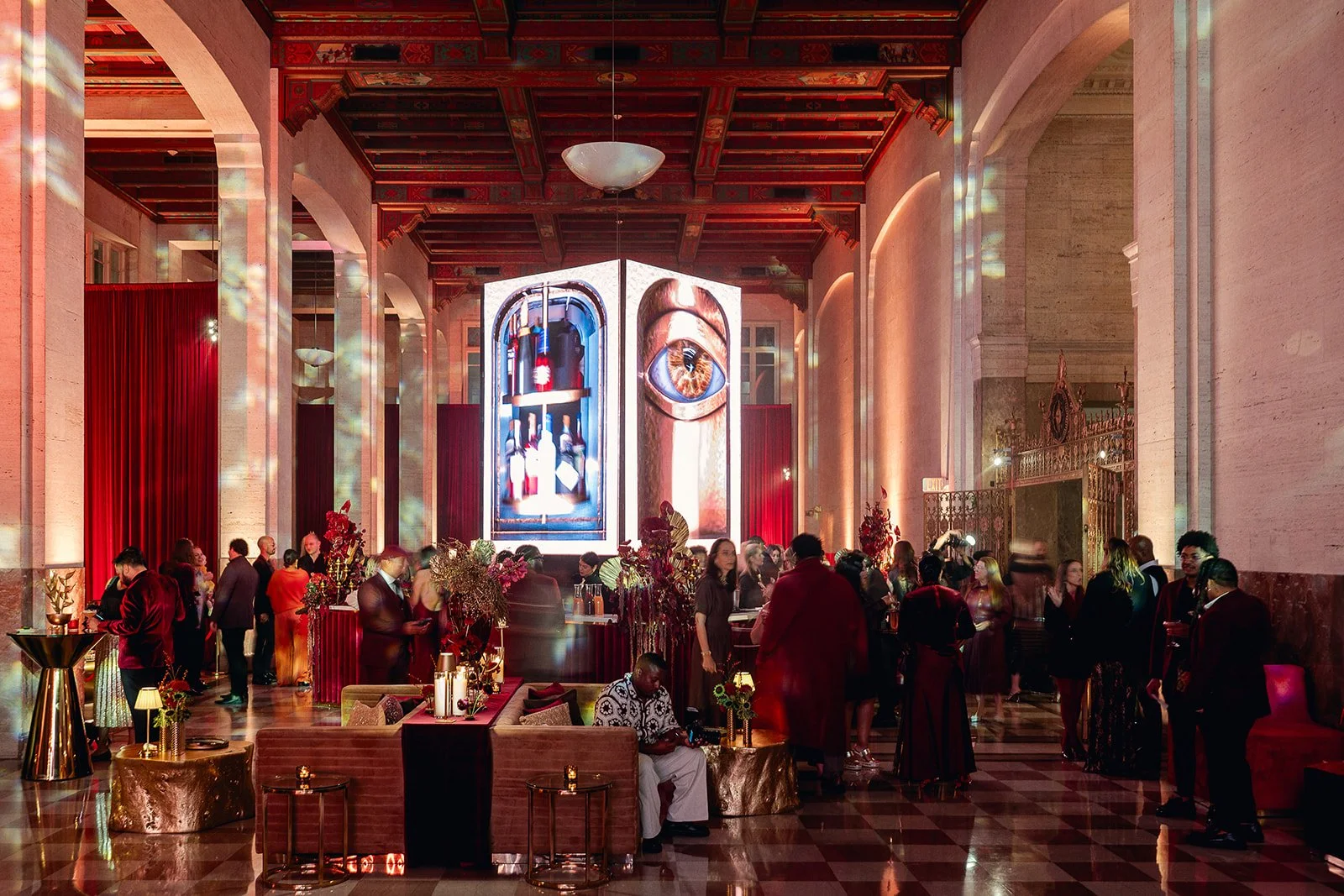 Full-scale experiential event production inside the Alfred I. duPont Building Miami featuring crimson velvet draping, LED art installation, and live entertainment -  Veils of Light Year 2 