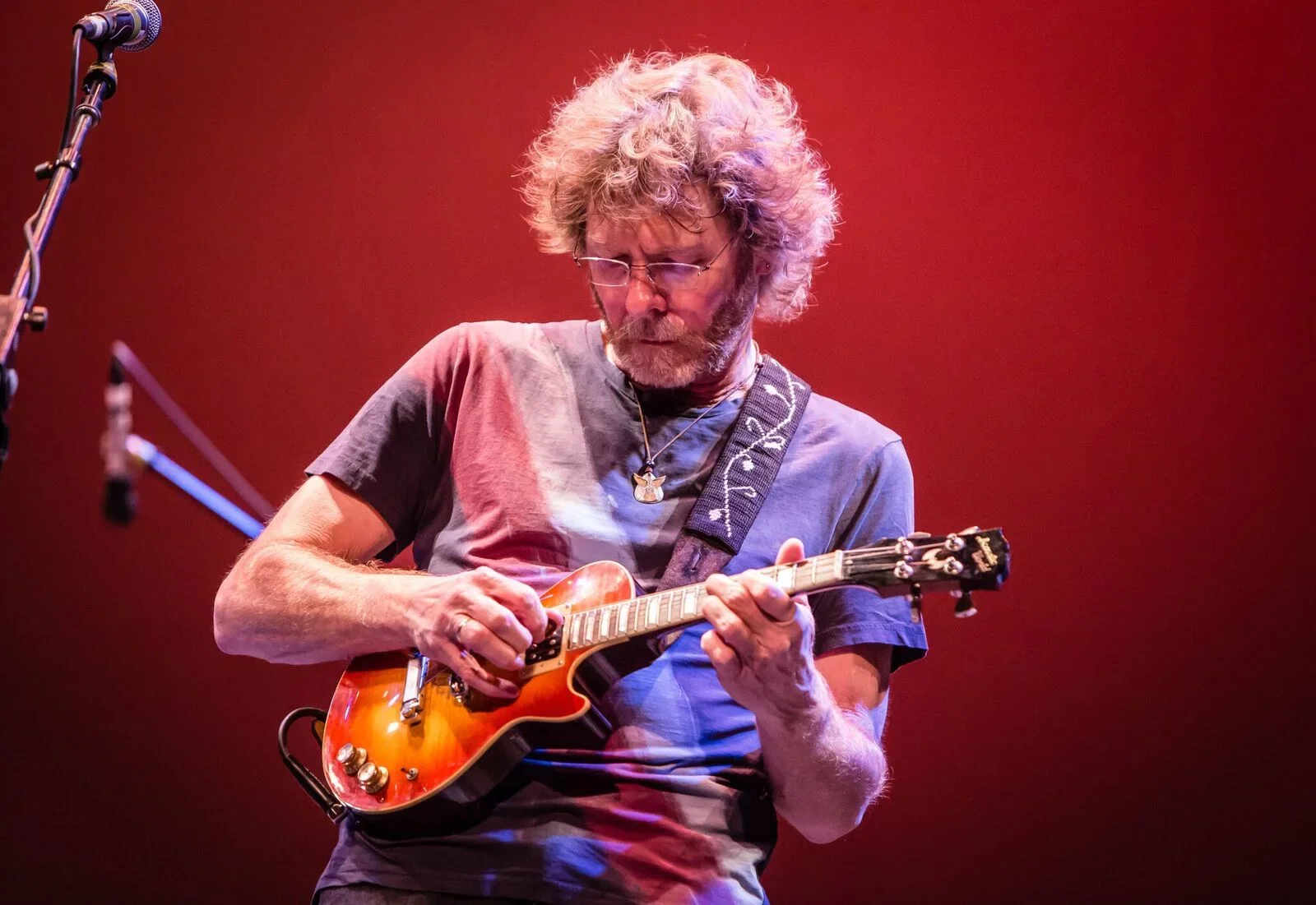Sam Bush on stage playing mandolin