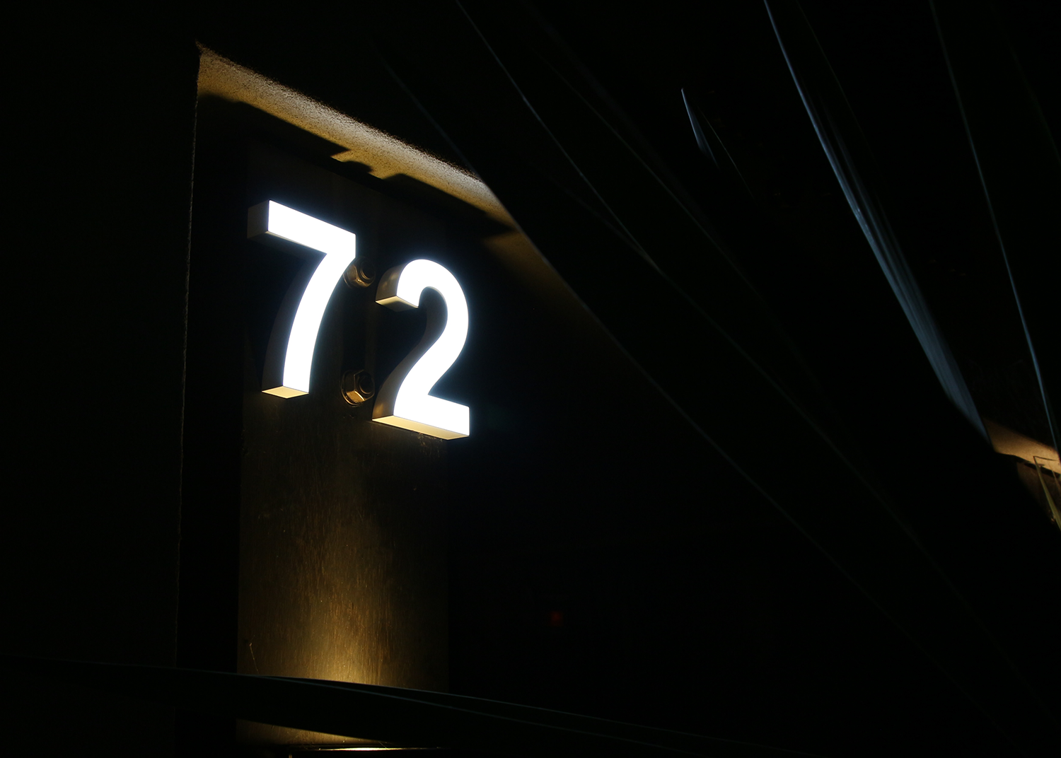 Front lit LED illuminated house number on a Sydney Australian house front.