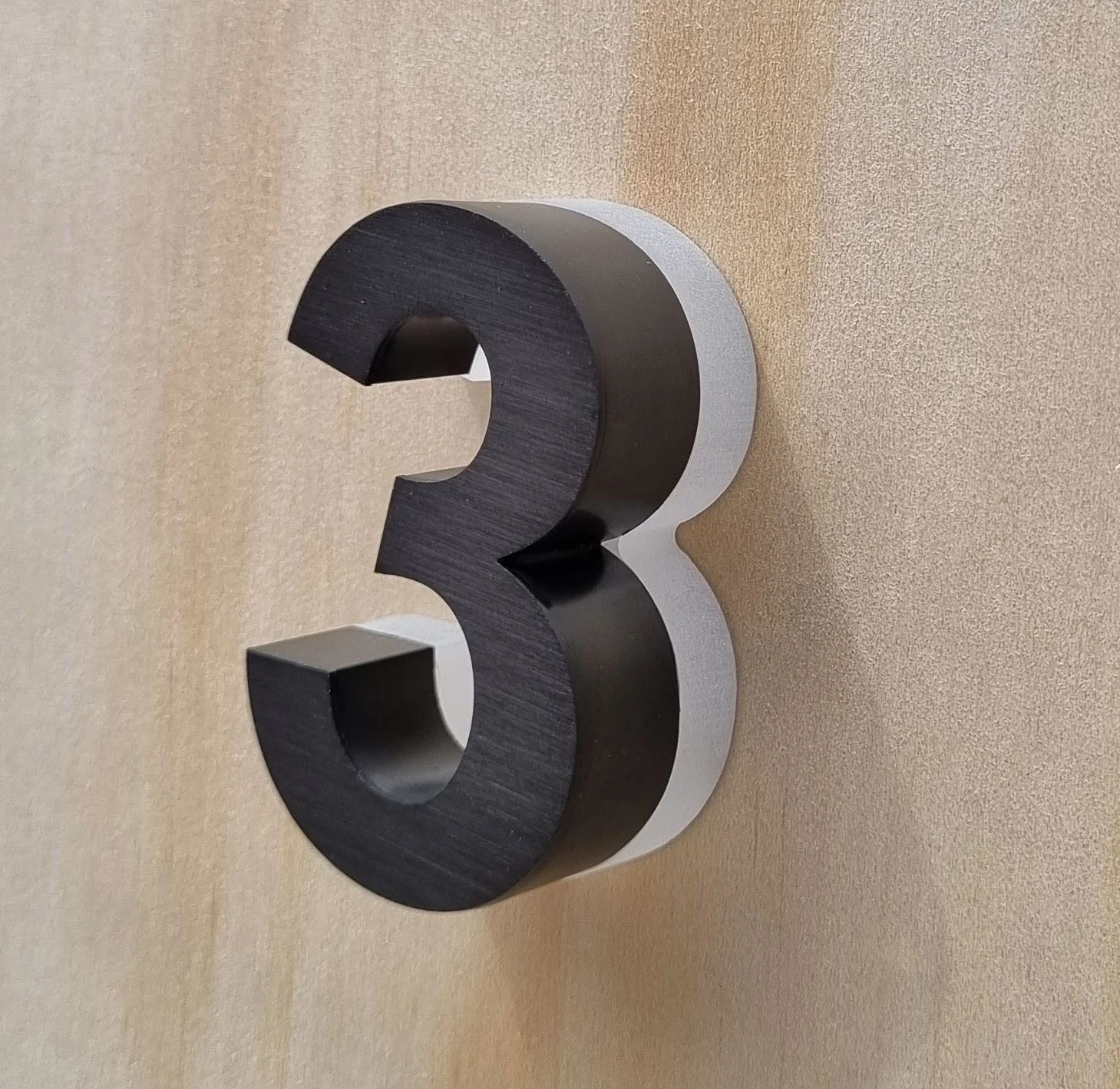Backlit halo-illuminated LED house number in Black brushed metal