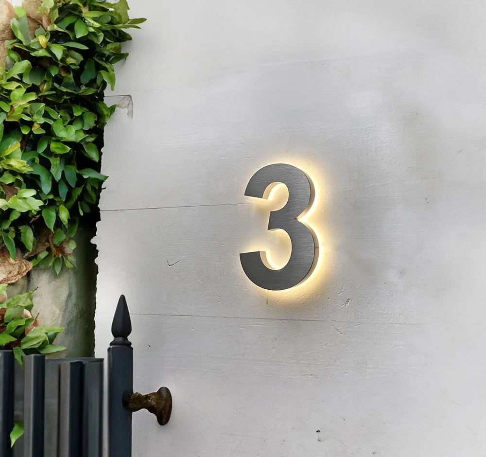 Backlit LED House Number '3' on wall by house front door
