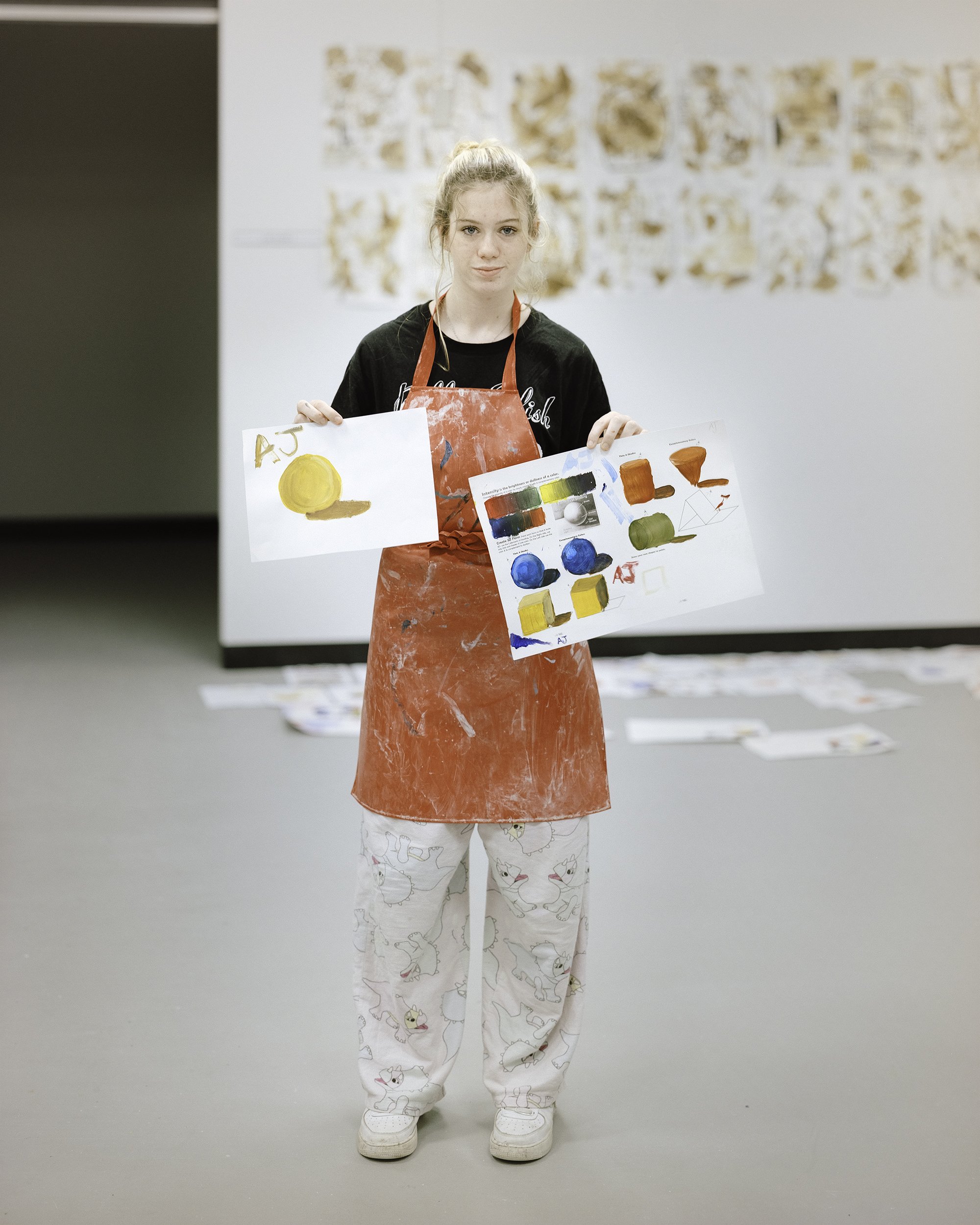 AJ, holding up her finished work (Year 9 Art class), 2022