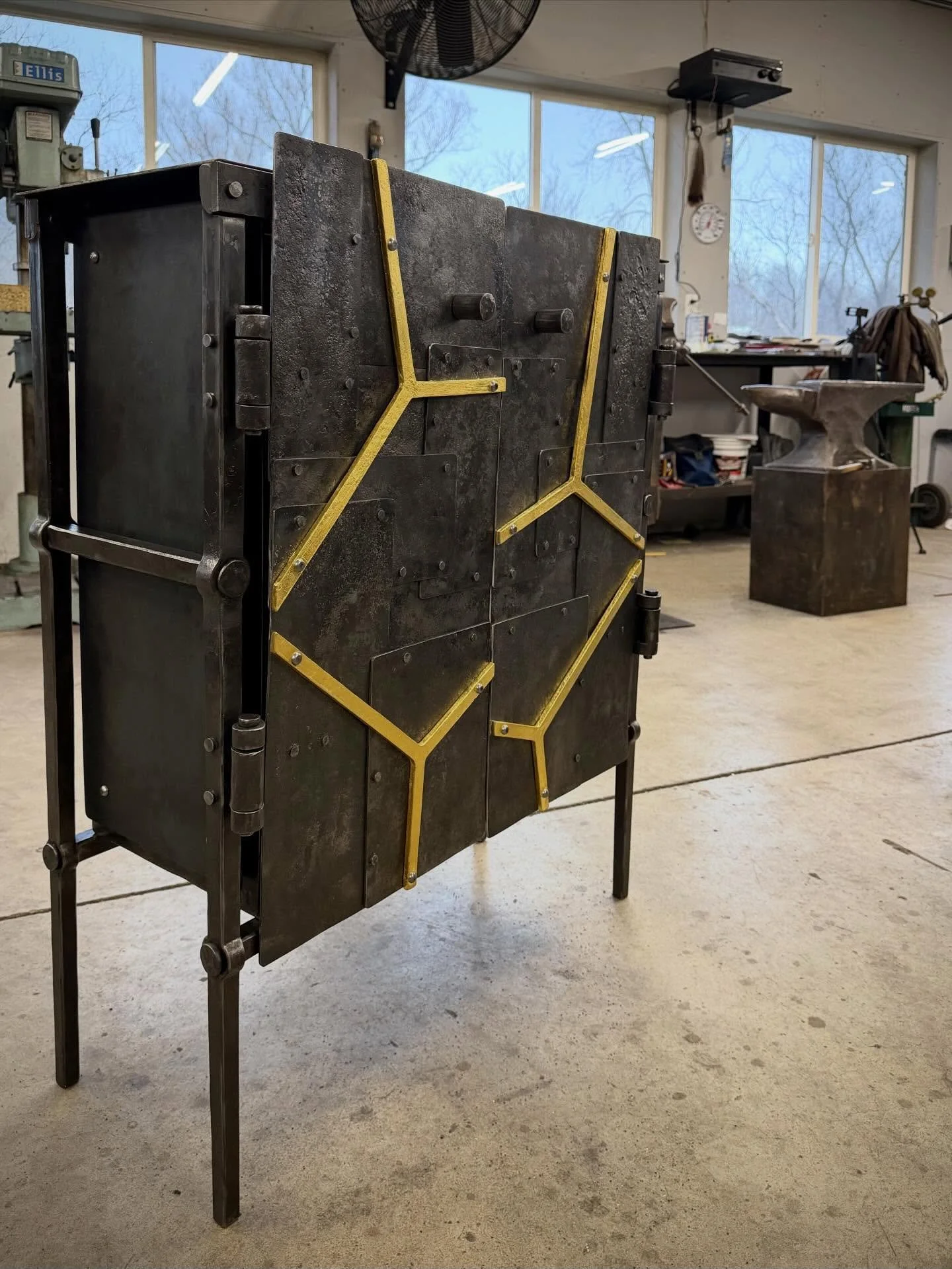New one for the art shows. The front is textured sheet steel all riveted together reminiscent of something you would see in large scale industrial forge shop. The triangle forms are forged from a single piece, additional length is add to the ends. Th