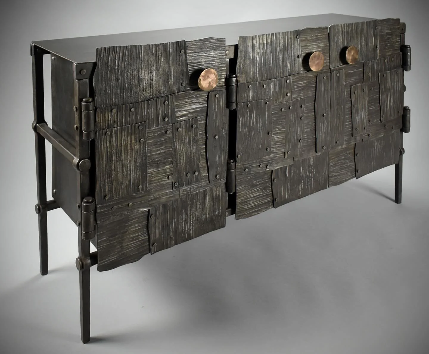 Another image for art show applications. Hopefully they work. 
Three door cabinet with pulls forged from .75&rdquo; bronze. 28&rdquo; high 50&rdquo; long 14&rdquo; deep. This also has an adjustable shelf.
#blacksmith #handmade #forged #contemporaryar