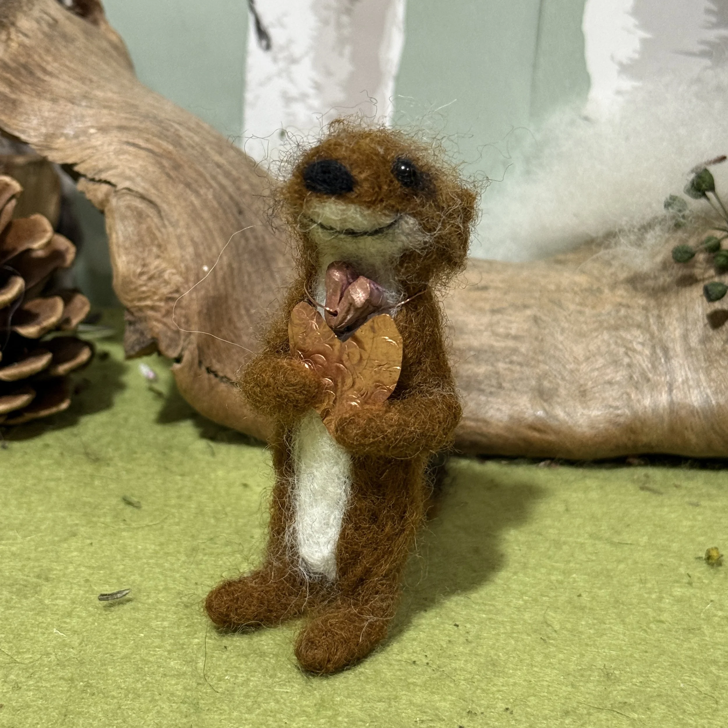 Stoat of love Needle felted stoat approx 7cm tall with a necklace of a heart cast in copper from a poppy seed head and carrying a copper heart to share with someone. Make someone you love smile! £85