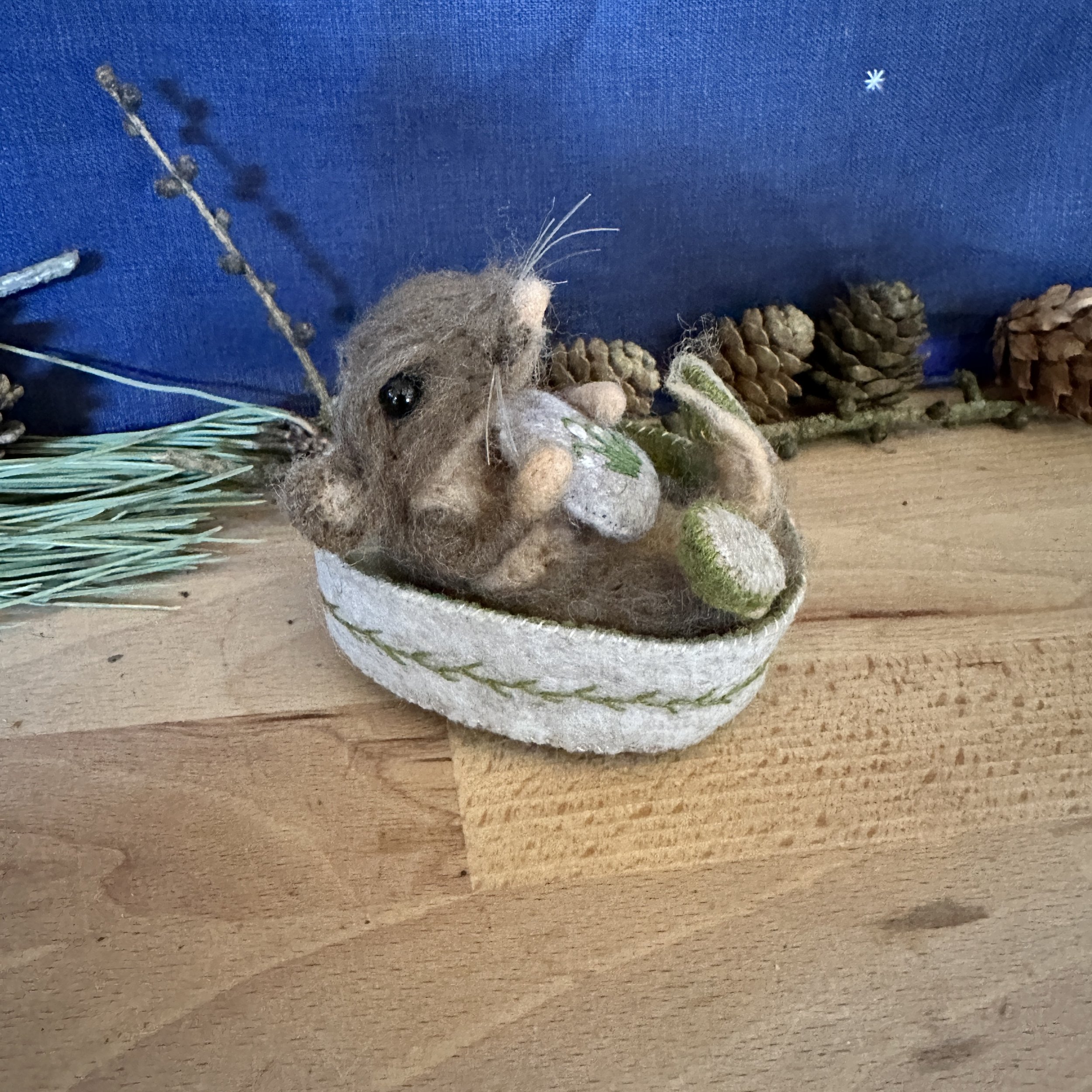 Mouse in embroidered bed