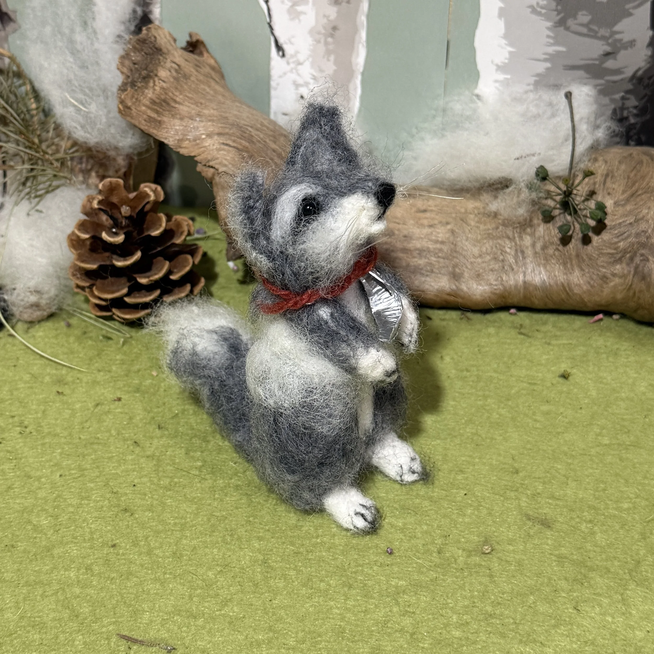 Baby Wolf Cub howling at the moon.  
Wolf cub 4 needle felted approx 11cm high  with a little hand beaten metal moon round their neck and a piece of red yarn to help you see which is which in photos . £130 