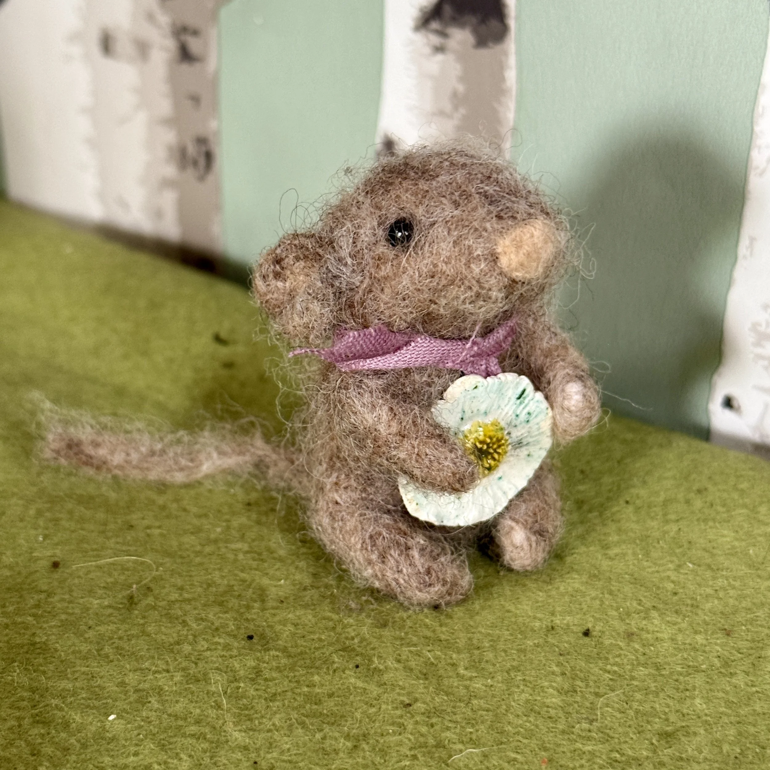 Small has a daisy flower they want to show you. Small has a ceramic flower and a plant dyed scarf. Approx 6cm tall £88