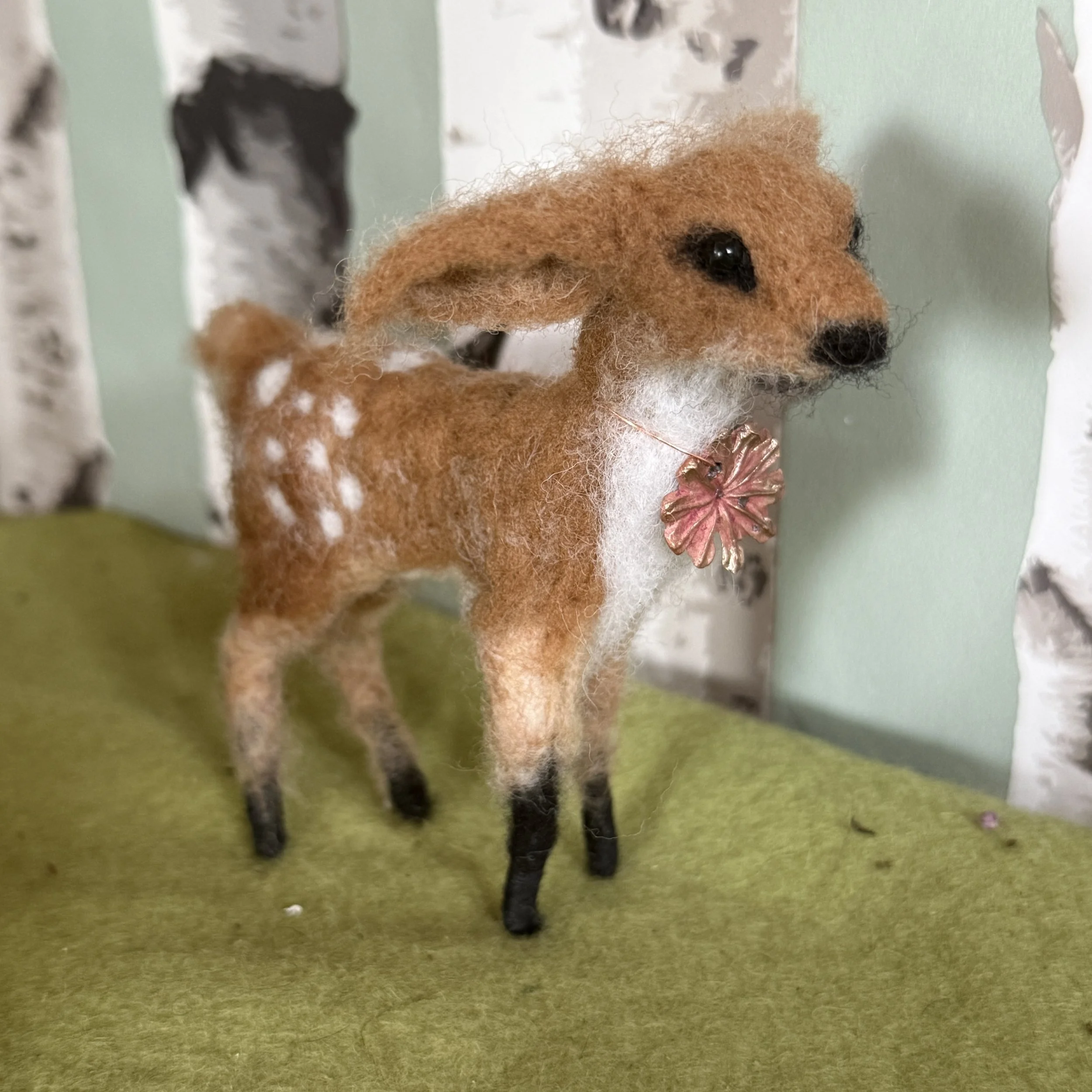 Osian, Little Deer. Approx 8cm long, 10 high. Needle felted deer to celebrate the birth of my Grandchild. They have a poppy head copper charm around their neck £130