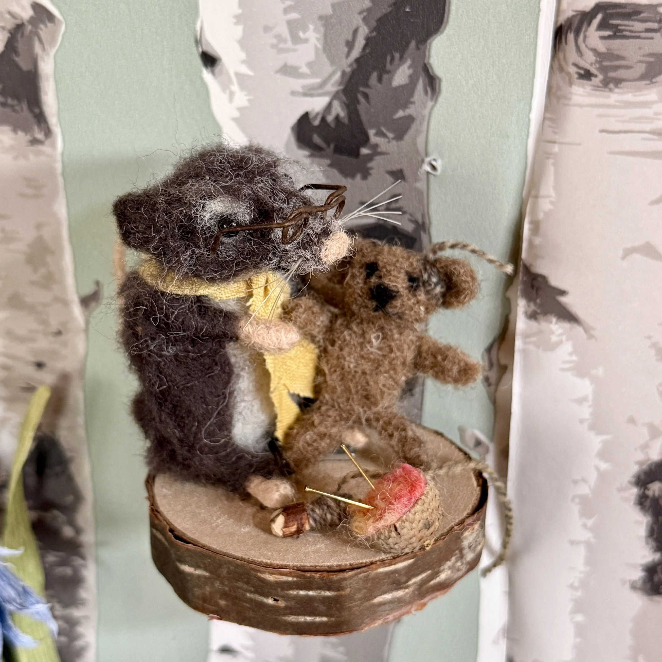Grandfather Shrew mending the teddy bear. Needle felted shrew with a little teddy bear with a stitched ear. Acorn cup pin cushion.  approx 7cm tall £130