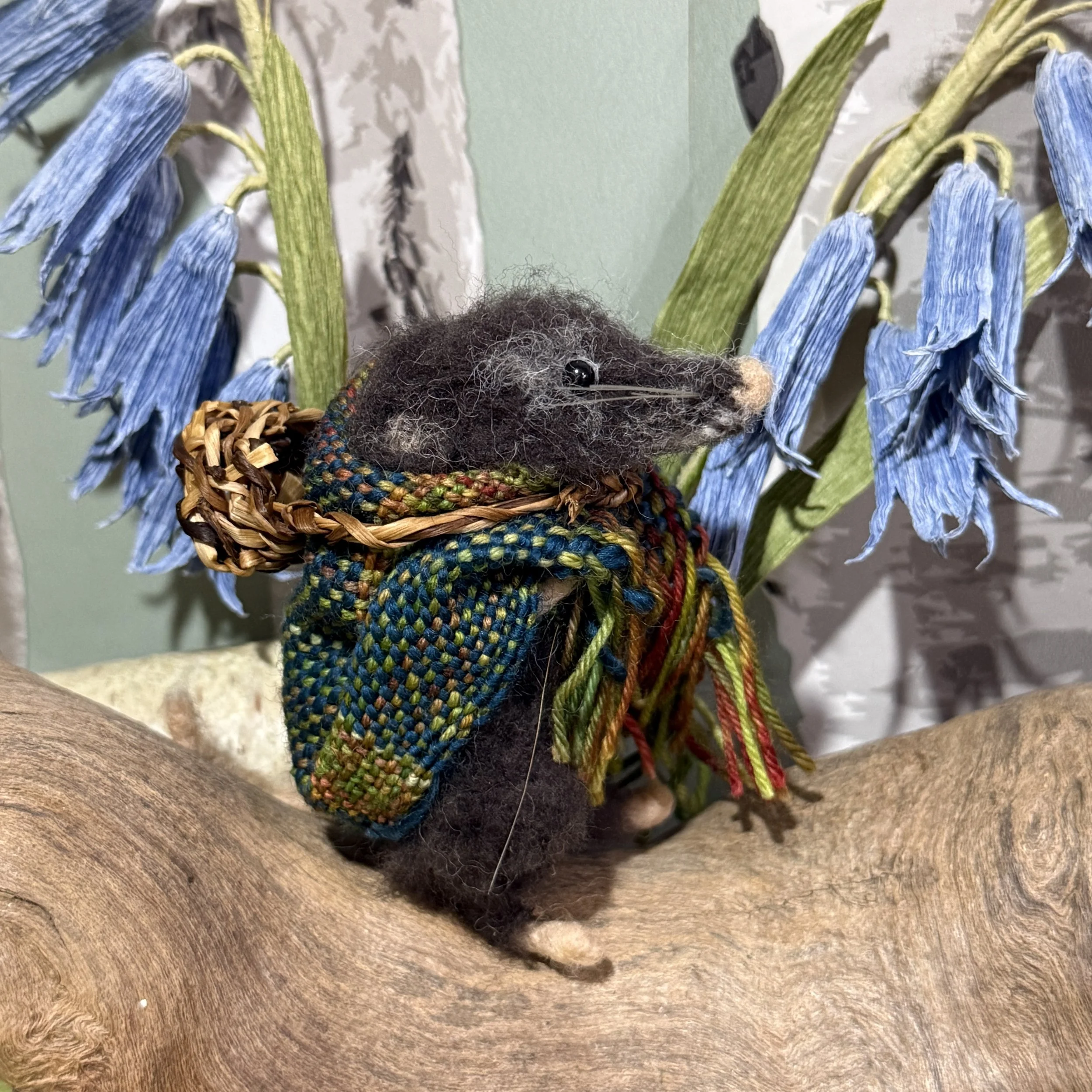 Grandmother Shrew with her hand woven shawl and basket gathering herbs for medicines. She is a drawing in the Gift Gatherers book Approx 9cm tall. £140