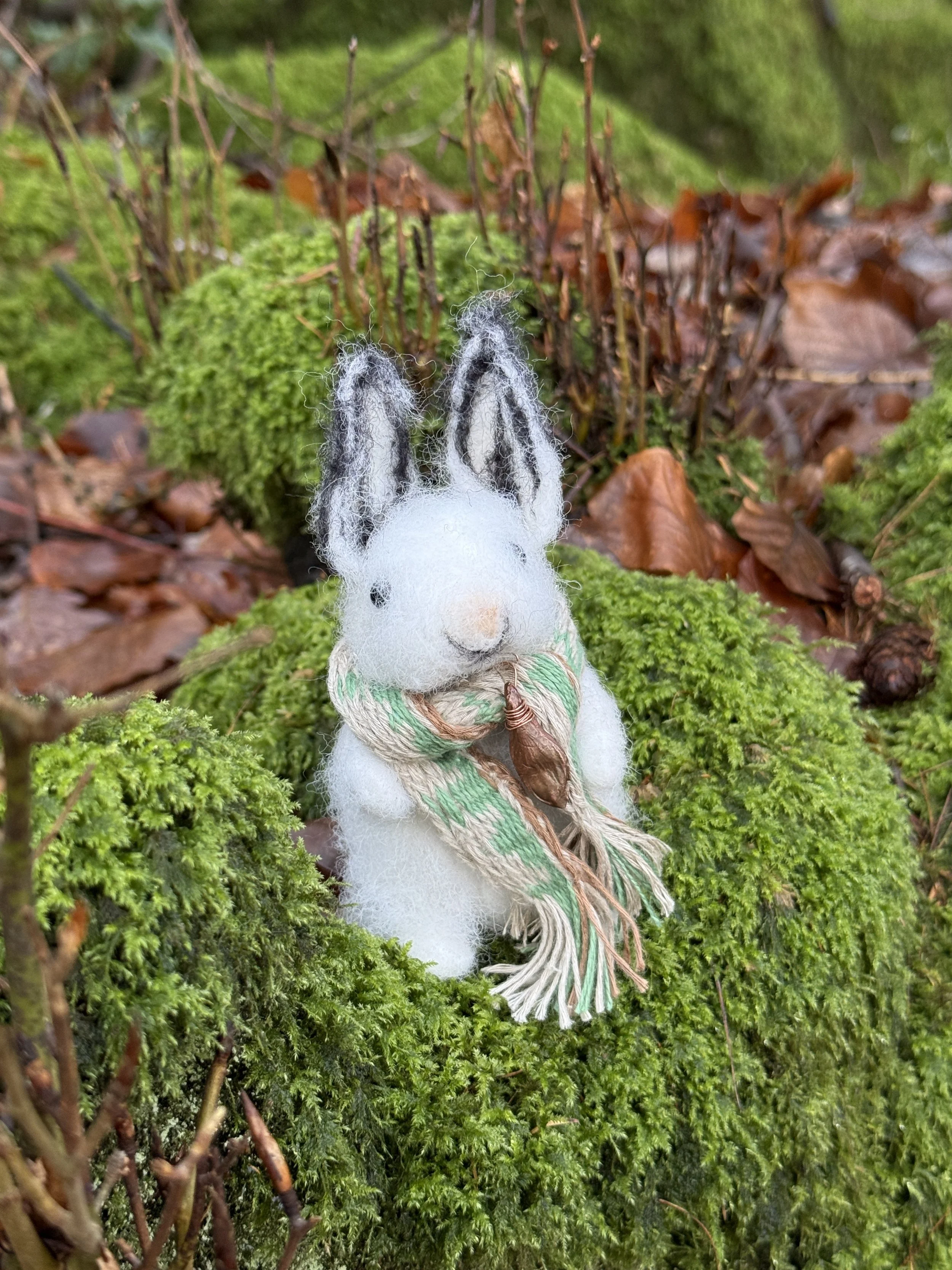 Arctic Hare with a handwoven scarf and a copper cast of a snowdrop petal to call in Spring. approx 11cm tall to tips of ears £130