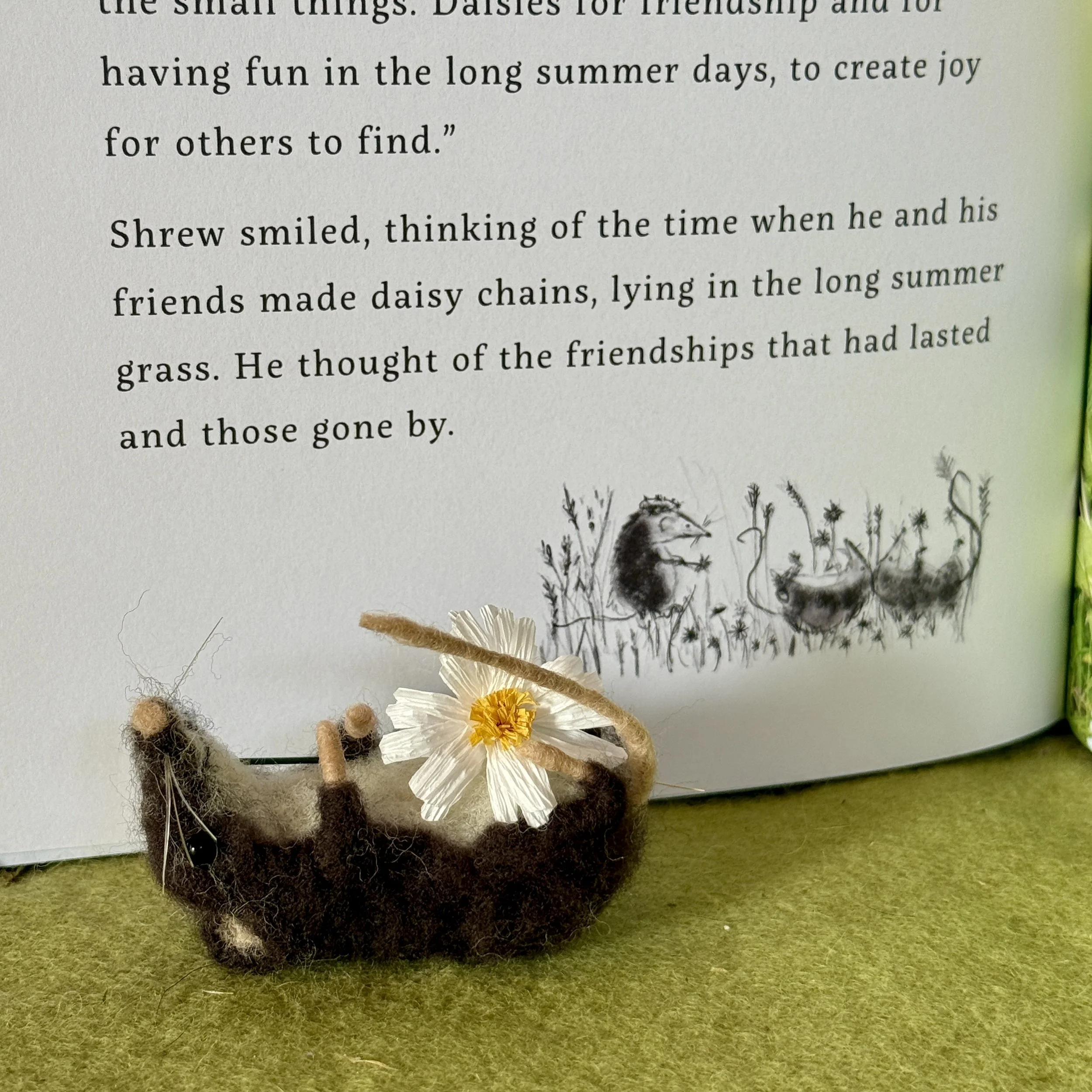 Lying back with the daisies from the gift gatherers book illustrations. Little felted shrew with a handmade plant dyed crepe paper daisy flower (paper from Paper by dragonfly Ling Approx 7cm long 