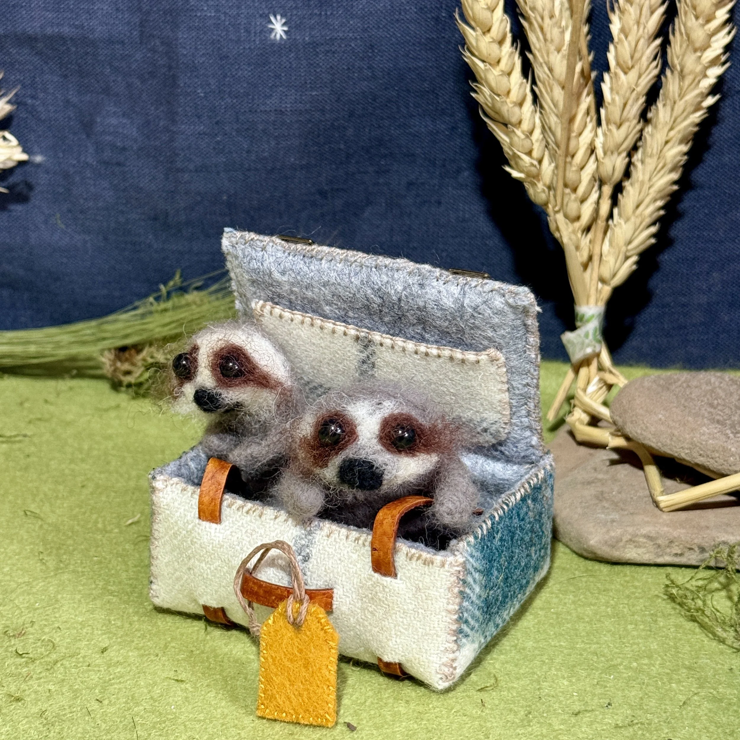 Kathy made a big suitcase and I just couldn't resist putting two tiny baby sloths in it. Like the pictures of them in buckets you see. Suitcase is 8cm wide with a blue tweed fabric and leather straps. The baby sloths are approx 5-6cm tall. £235